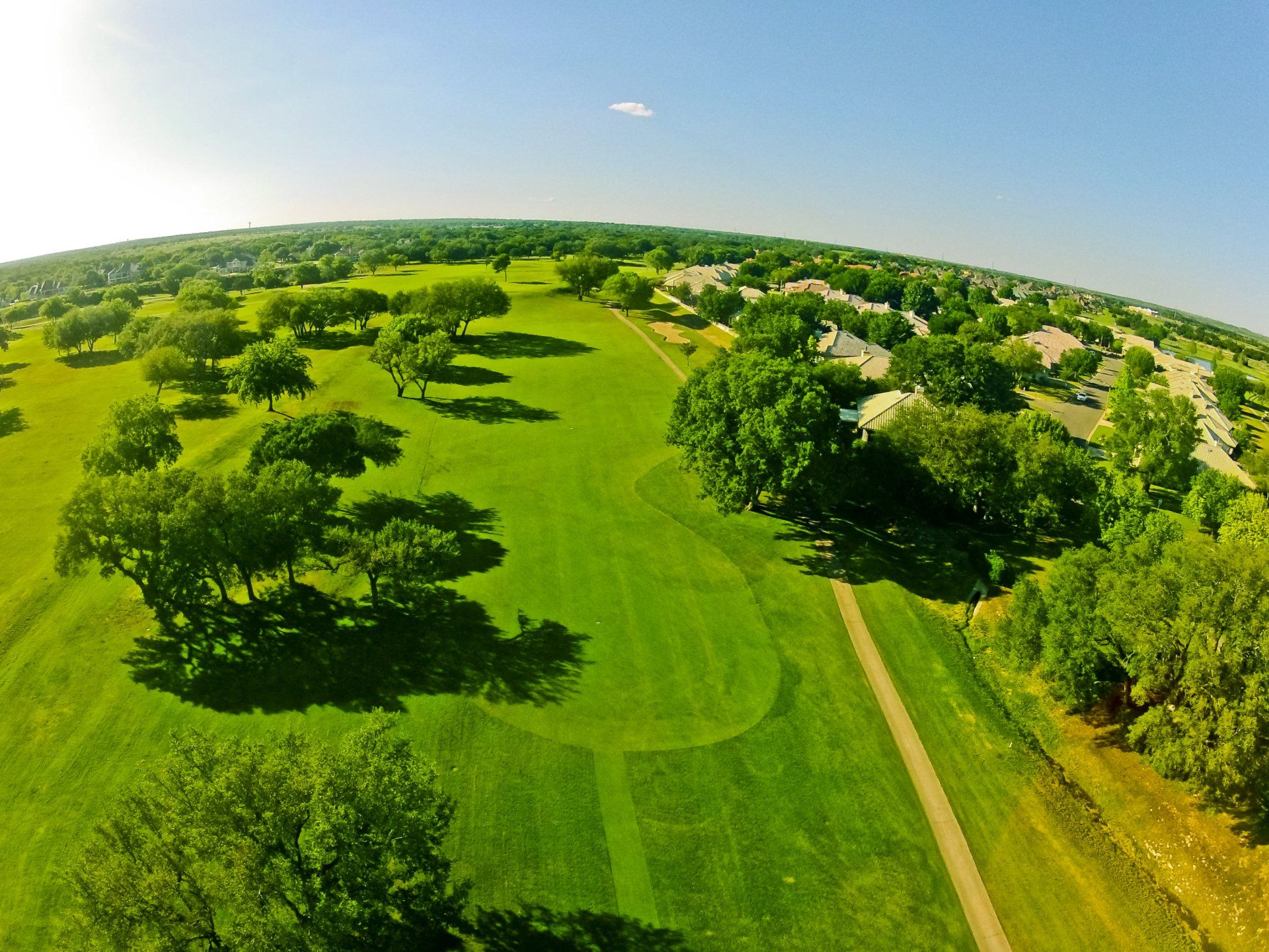 An aerial view of a golf course surrounded by trees