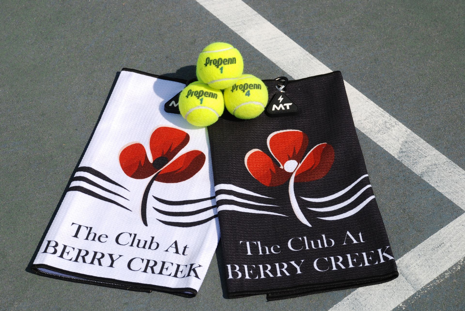 A woman is holding a tennis racquet on a tennis court.