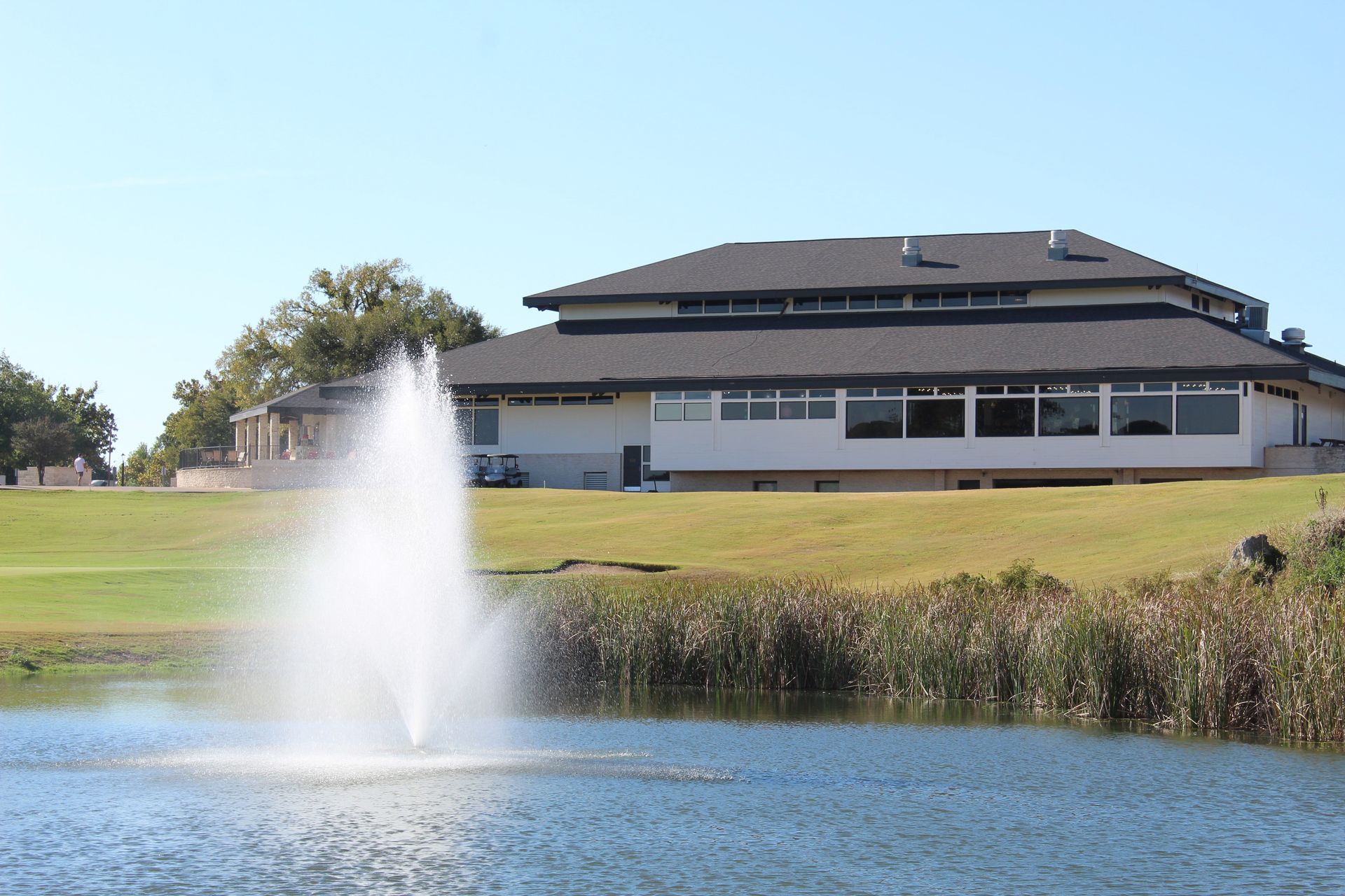 A large building with a green flag in front of it.