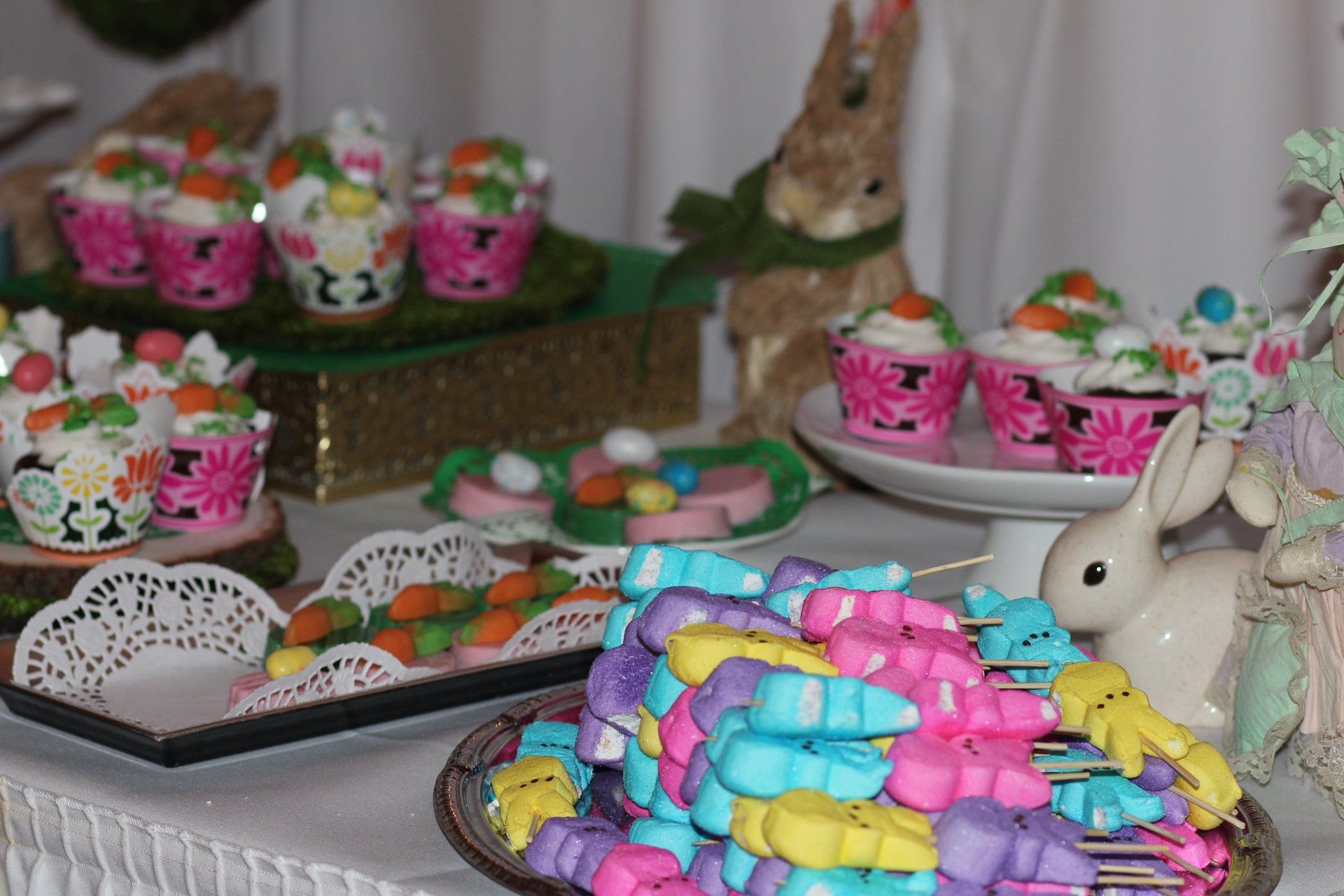 A table with a bunch of candy and cupcakes on it
