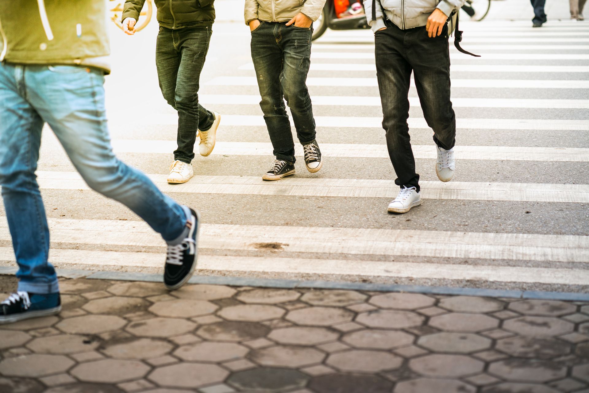 A group of people are walking across a crosswalk.