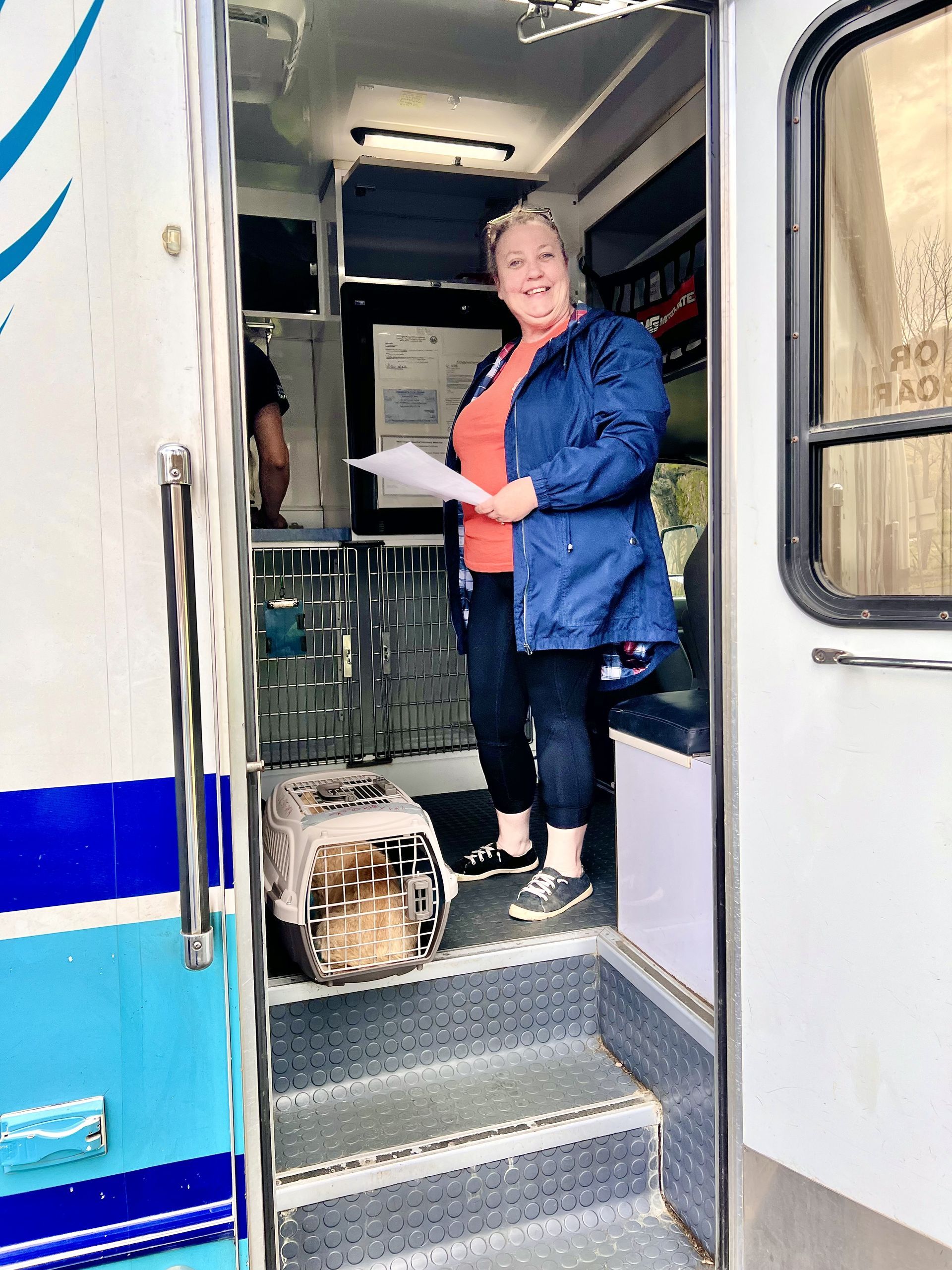 A woman checking in pets for a spay and neuter traveling event.