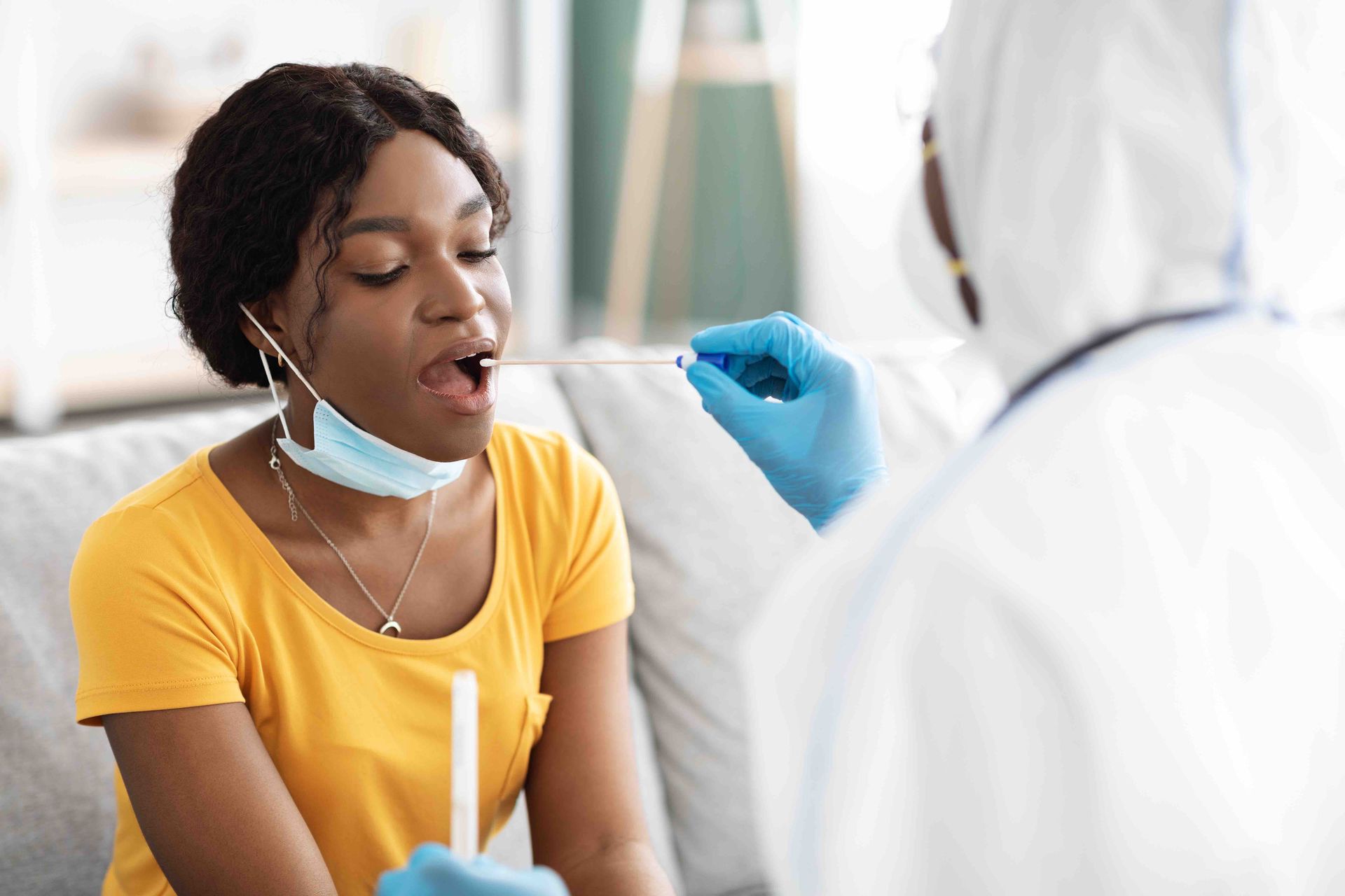 girl getting her throat swabbed