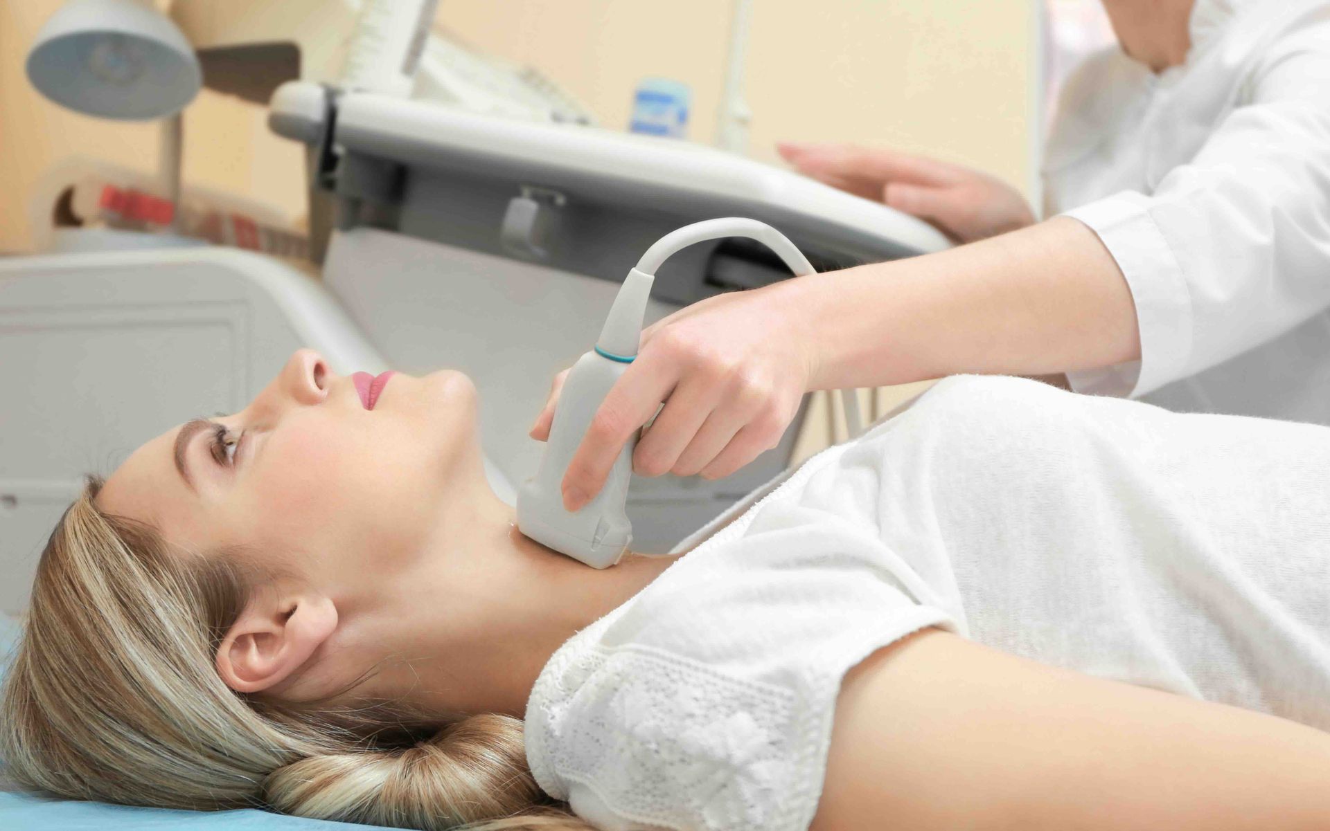 A woman is getting an ultrasound of her neck.