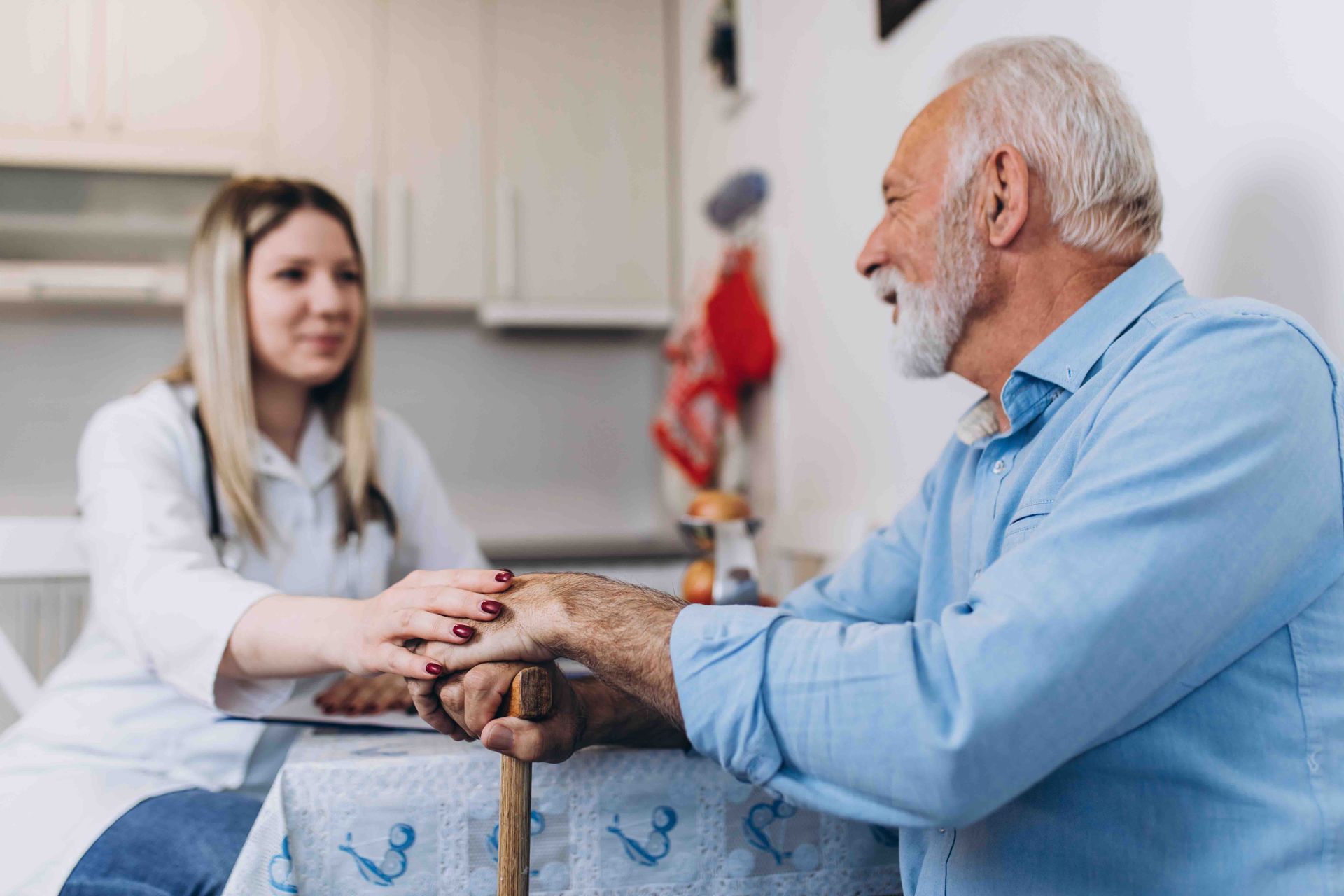 an older man and nurse talking in an office