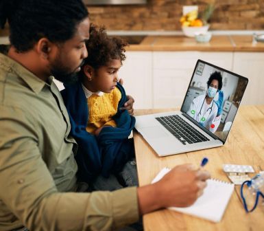 female child coloring with supervisor taking notes