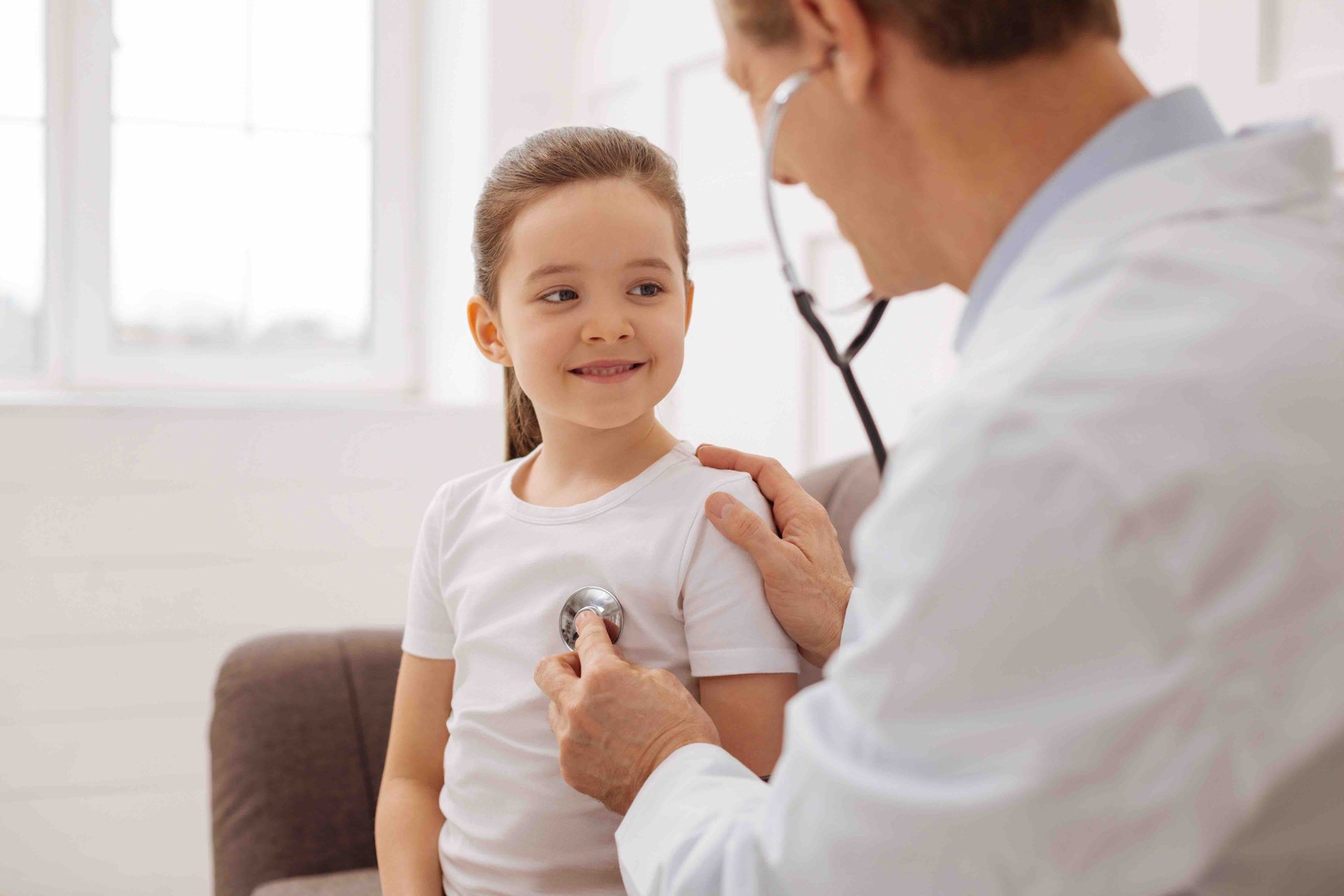 doctor listening to a child's heartbeat