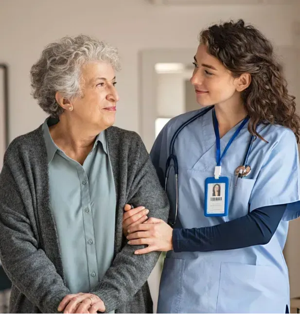 A nurse is holding the arm of an older woman