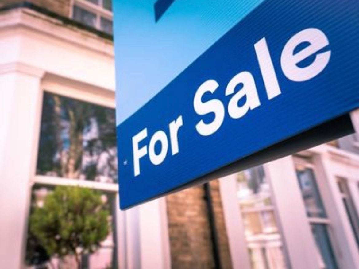 A man in a suit is holding a piece of paper in his hand.
