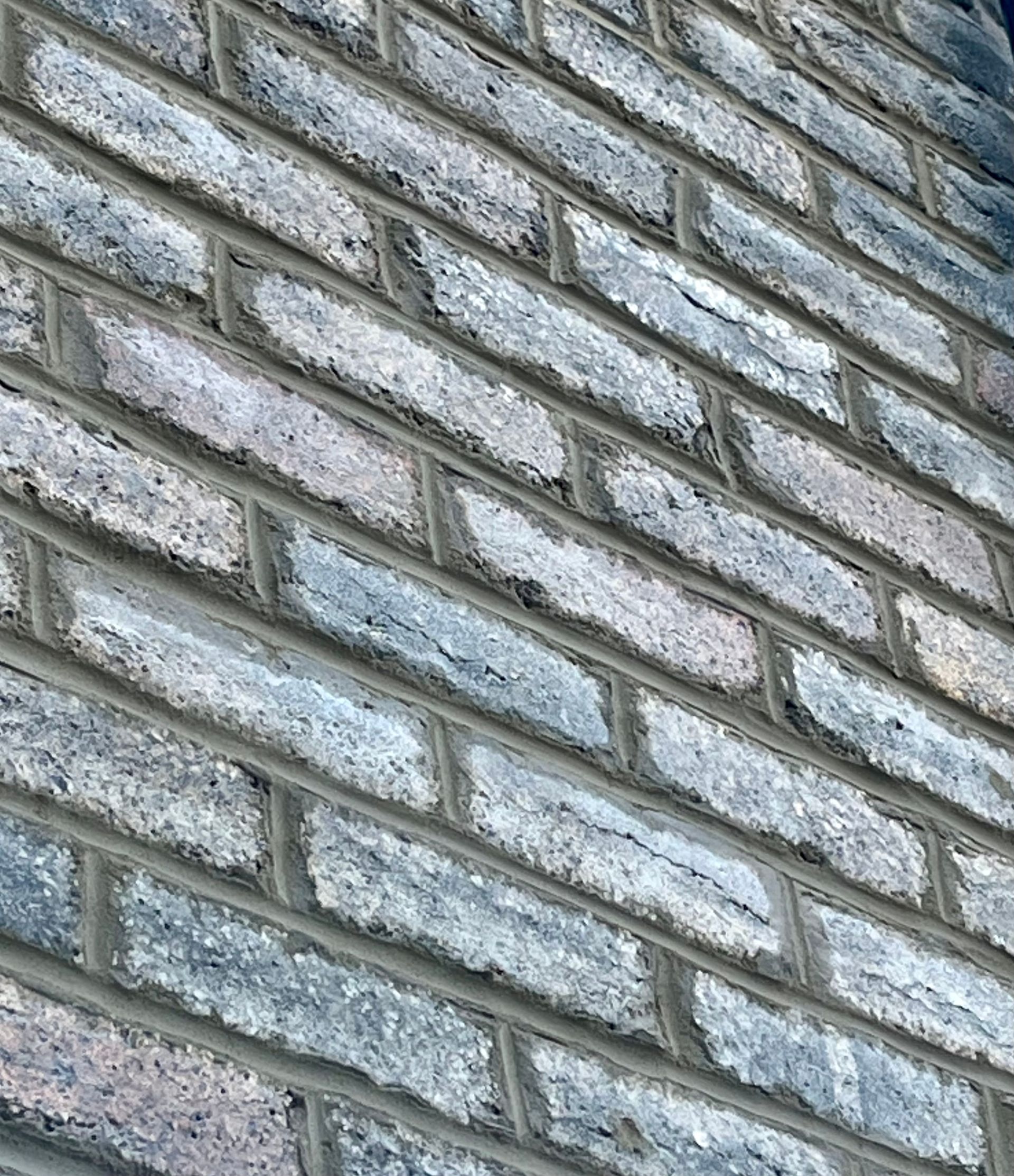 Looking up at a group of tall buildings with a blue sky in the background.