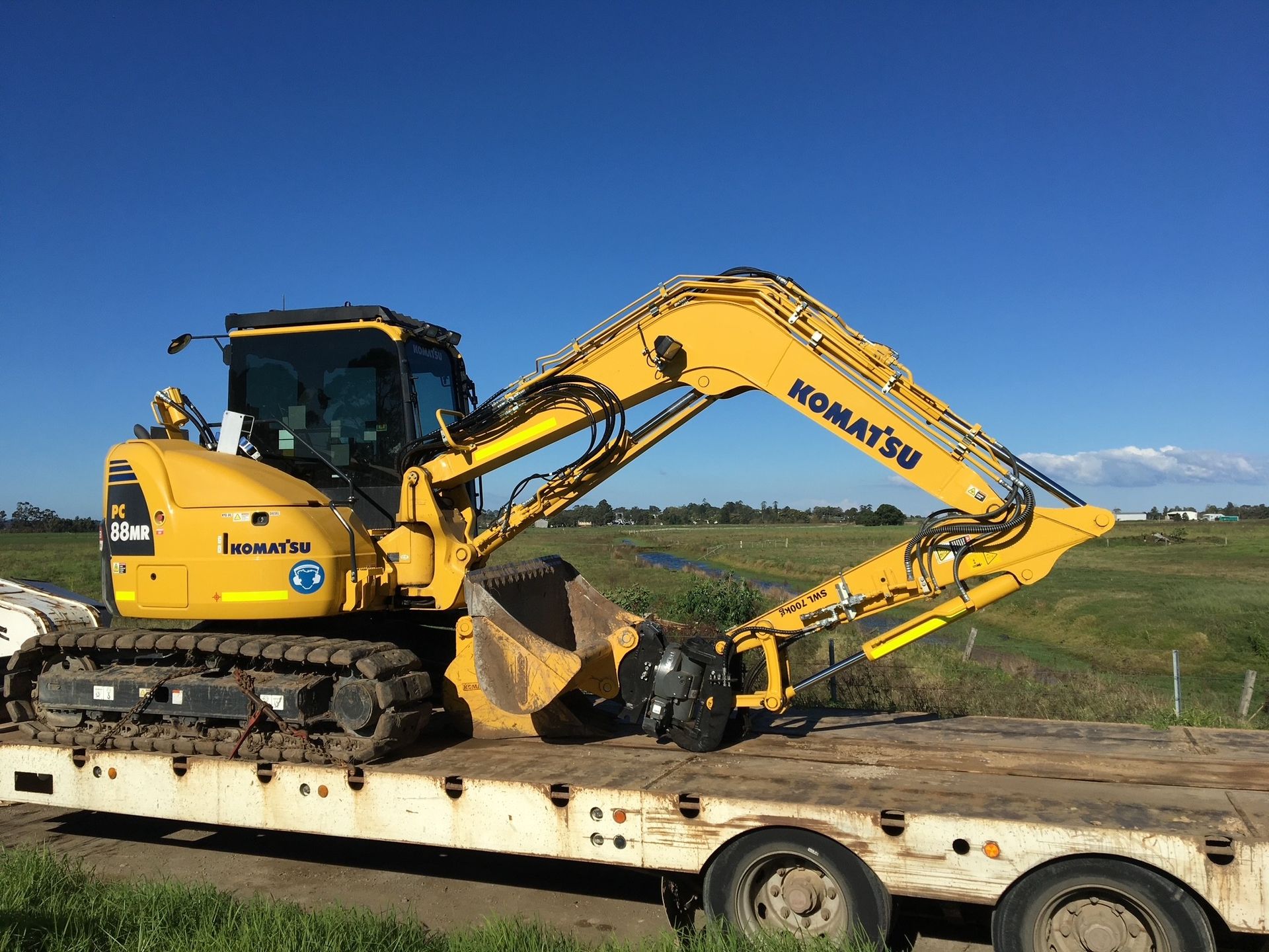 An excavator on a truck being transported — Lantry Earthmoving in Phoenix Park, NSW