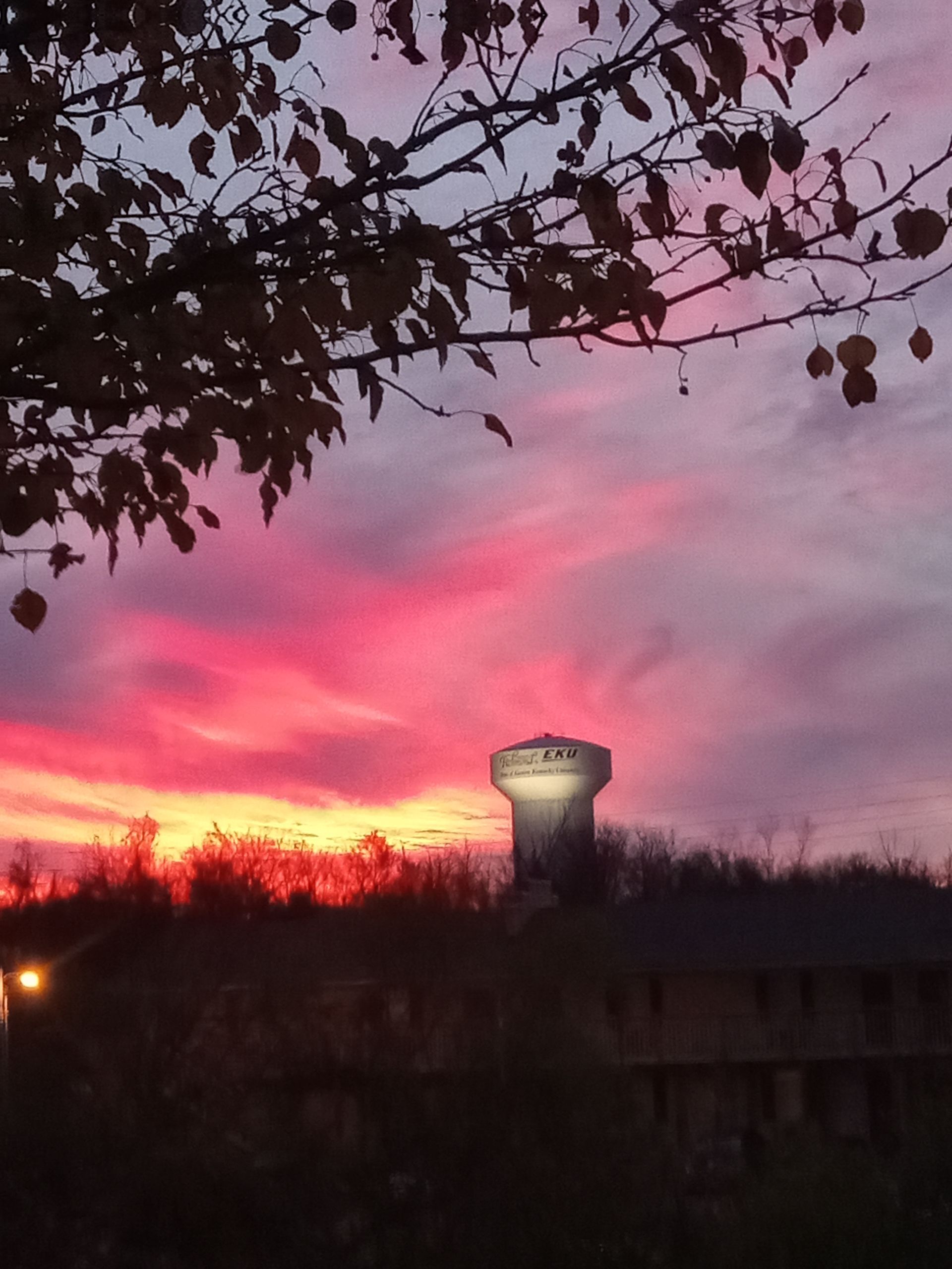 A sunset with a water tower in the foreground