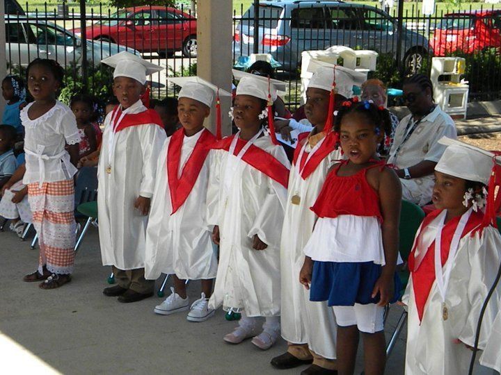 A group of children wearing graduation caps and gowns