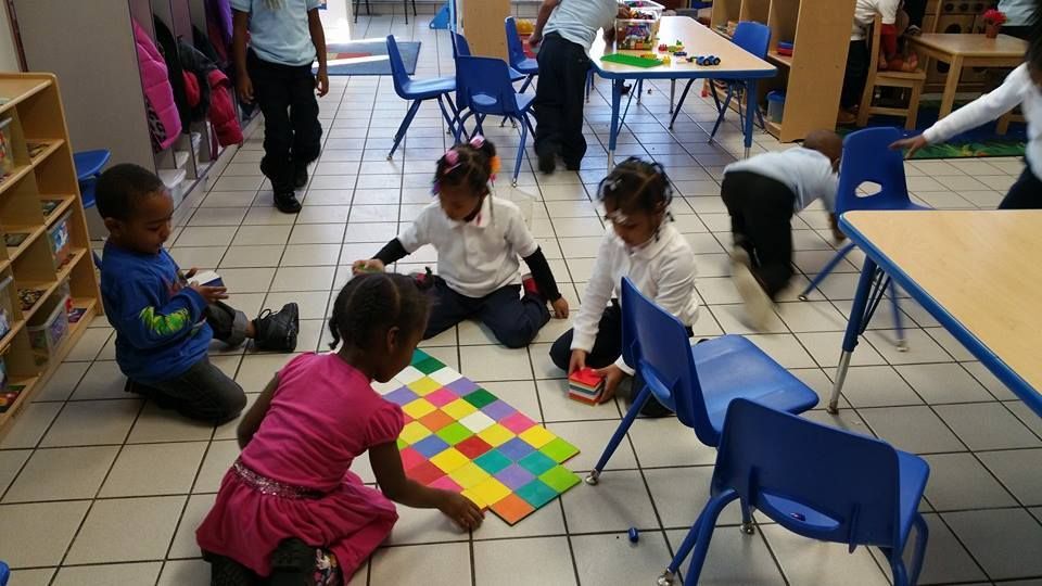A group of children are playing a game in a classroom