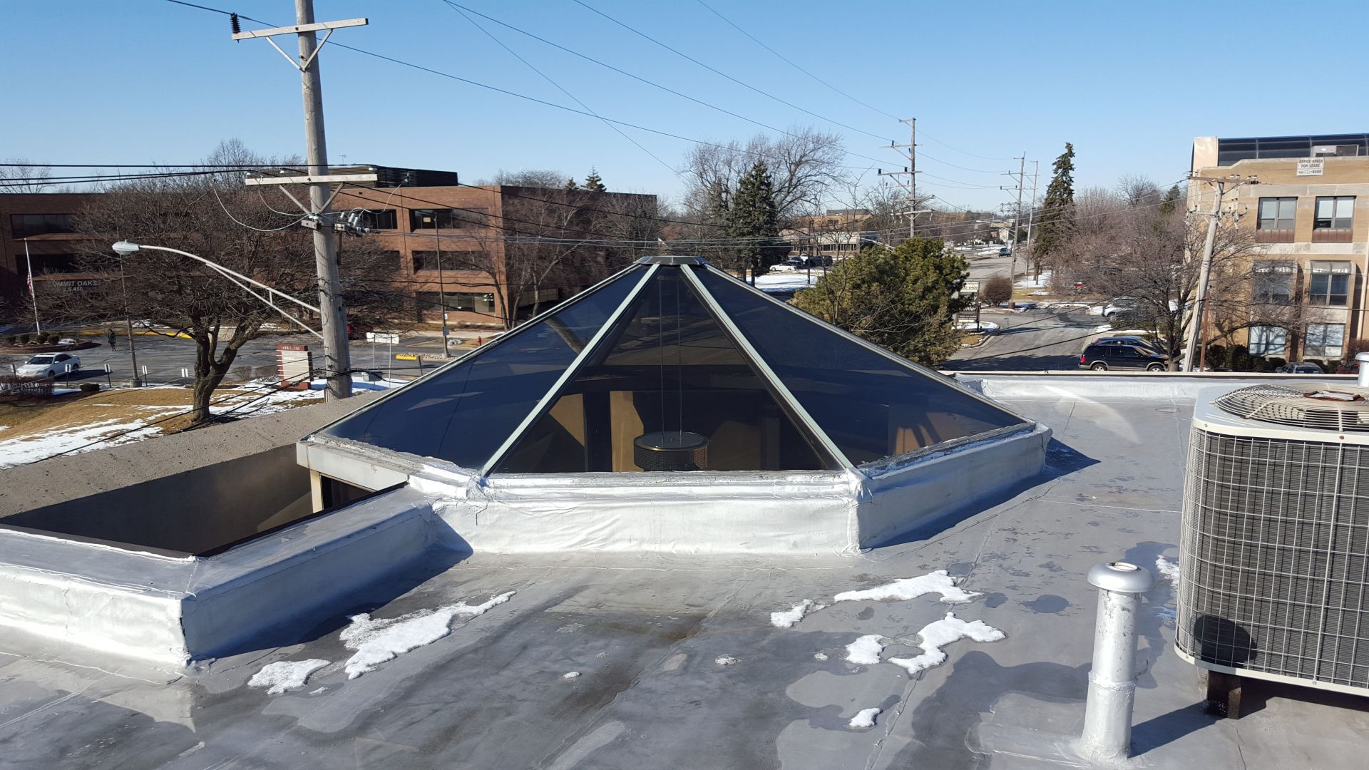 A pyramid shaped skylight on the roof of a building