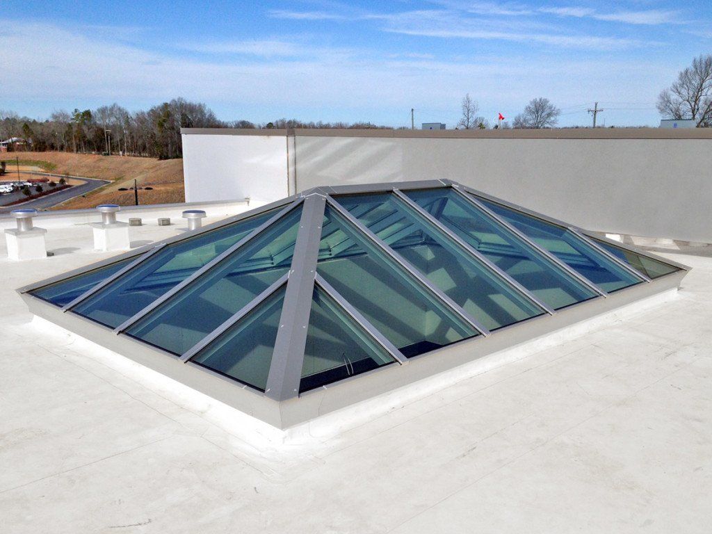 A pyramid shaped skylight on the roof of a building.