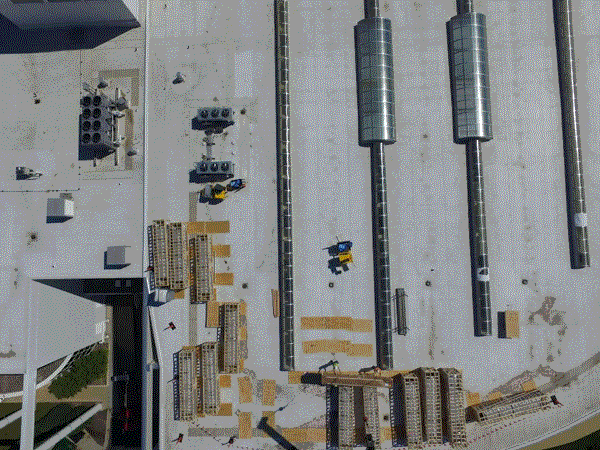 An Aerial View of a Building with a Lot of Pipes on It
