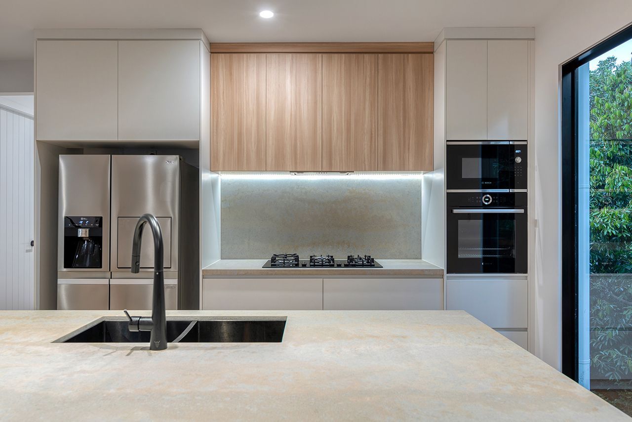 A kitchen with stainless steel appliances and wooden cabinets