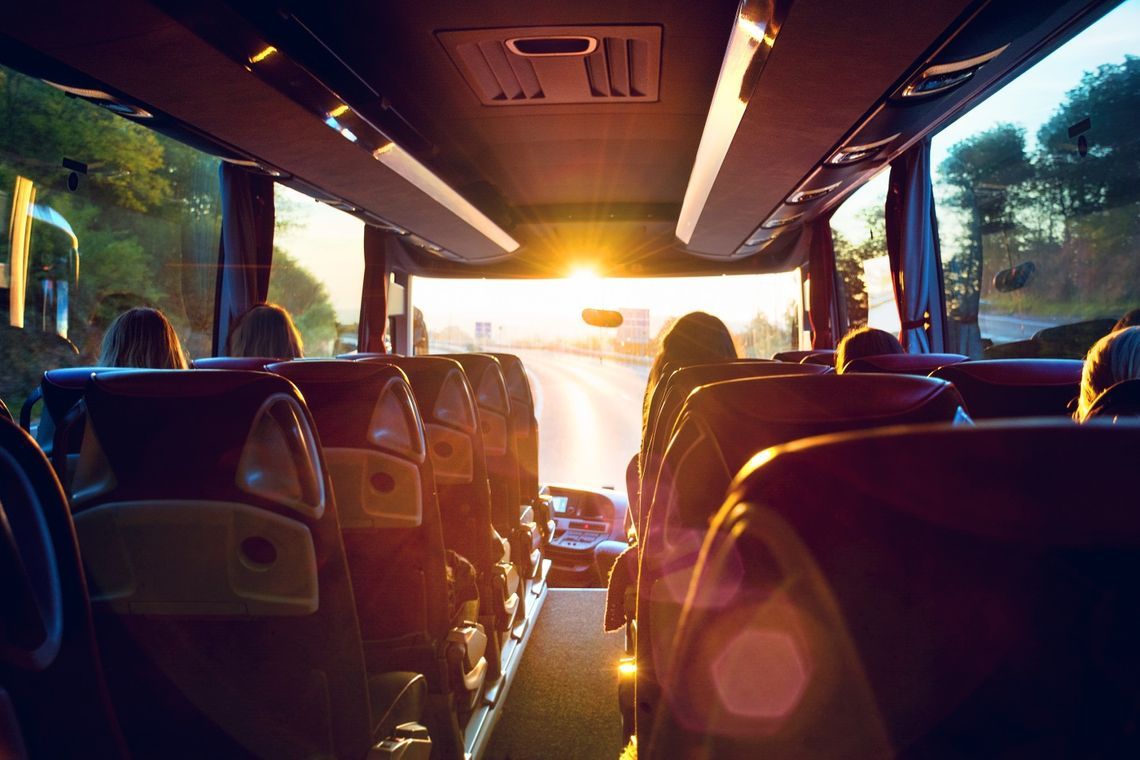 The sun is shining through the windows of a bus.