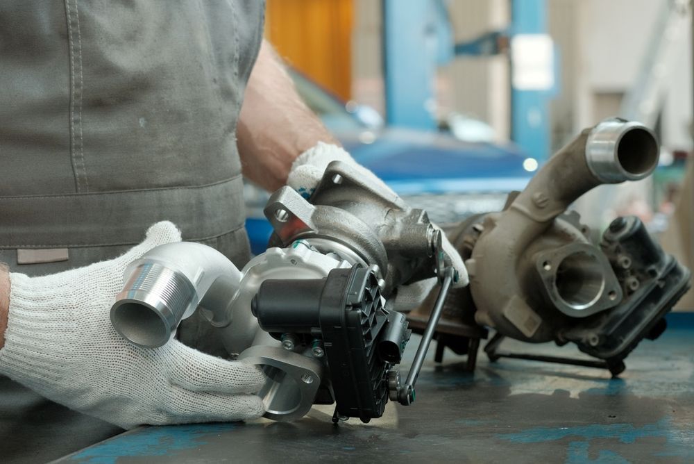 A Man is Working on a Turbocharger in a Garage — Mick Dunn Motor Repairs in Mackay, QLD