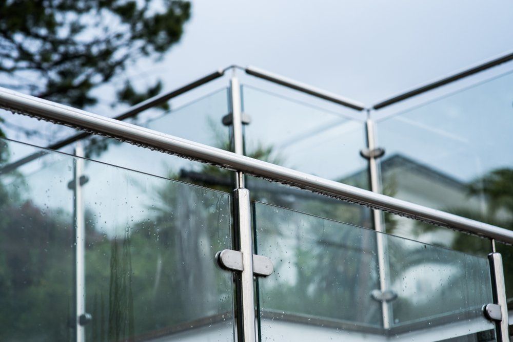 A Close up Of a Glass Railing on A Balcony — Glass Pool Fencing Australia in Smiths Lake, NSW
