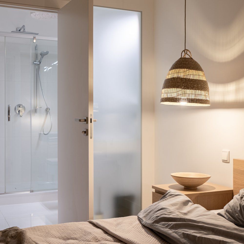 A Bedroom with A Bed and A Bowl on A Nightstand — Glass Pool Fencing Australia in Taree, NSW