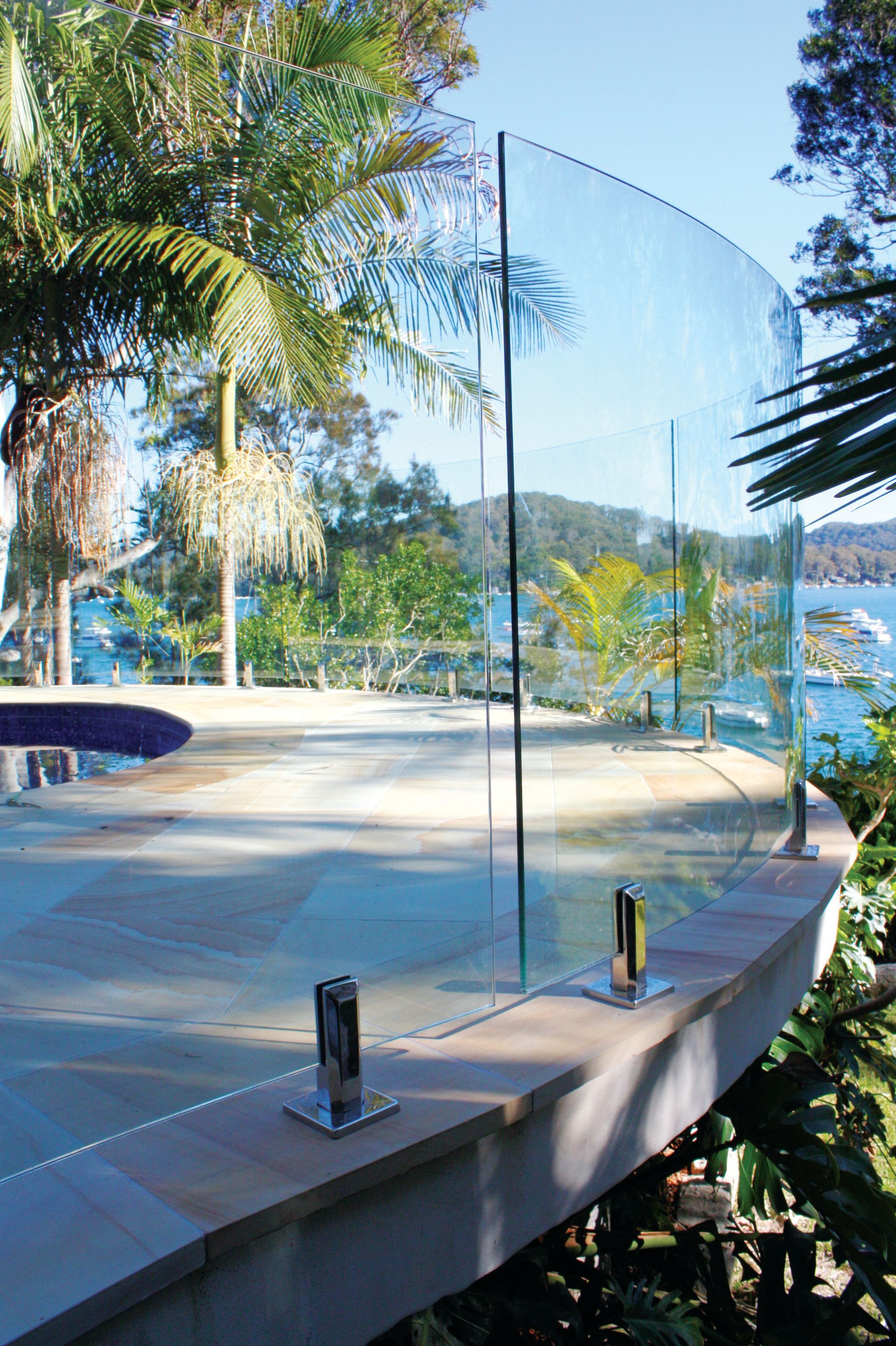 A Curved, Frameless Glass Pool Fence — Coastline Glass Pool Fencing in Old Bar, NSW