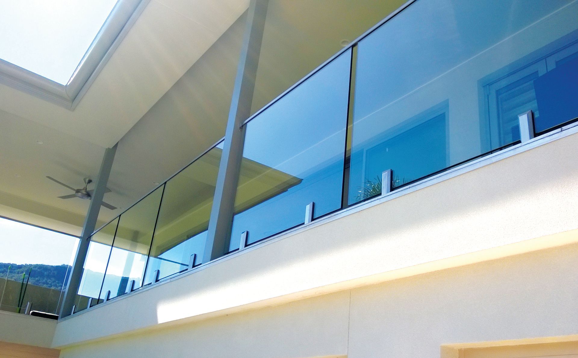 A Modern Balcony Featuring Clear Glass Panels Secured — Coastline Glass Pool Fencing in Old Bar, NSW
