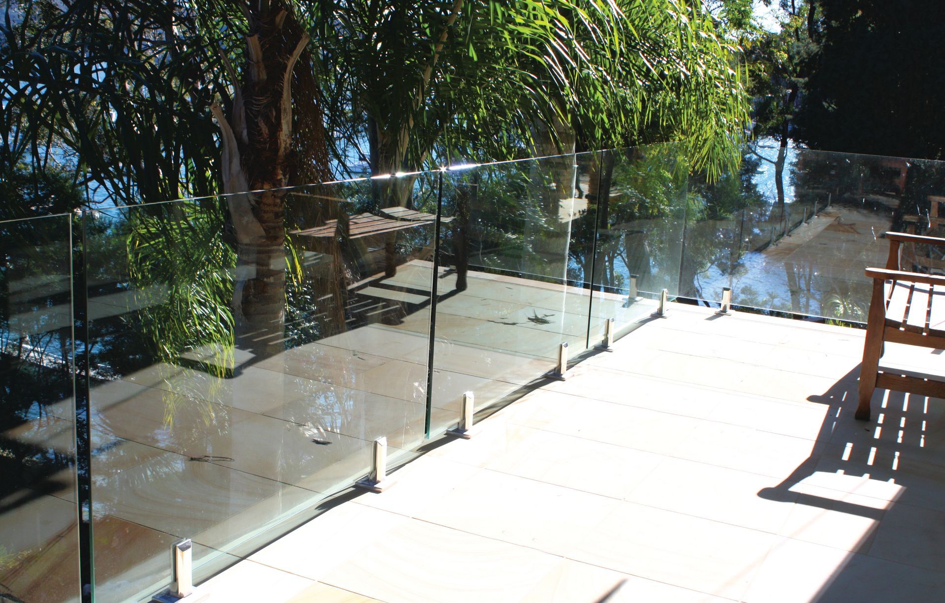 Glass Railing with Metal Spigots on A Light-Tiled Deck — Coastline Glass Pool Fencing in Old Bar, NSW