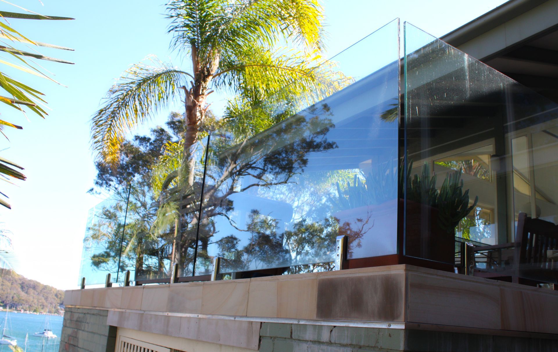 A Modern Glass Railing on A Stone Balcony — Coastline Glass Pool Fencing in Old Bar, NSW