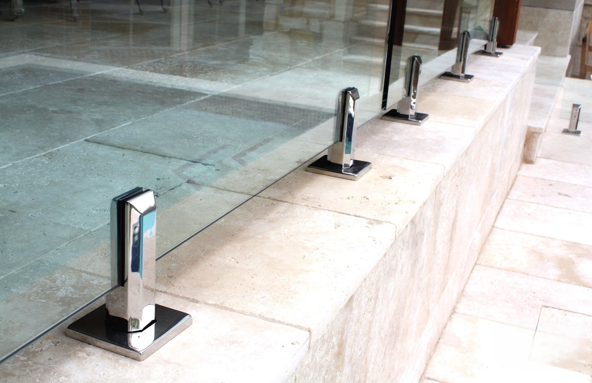 A Row of Shiny Chrome Glass Railing Spigots — Coastline Glass Pool Fencing in Old Bar, NSW