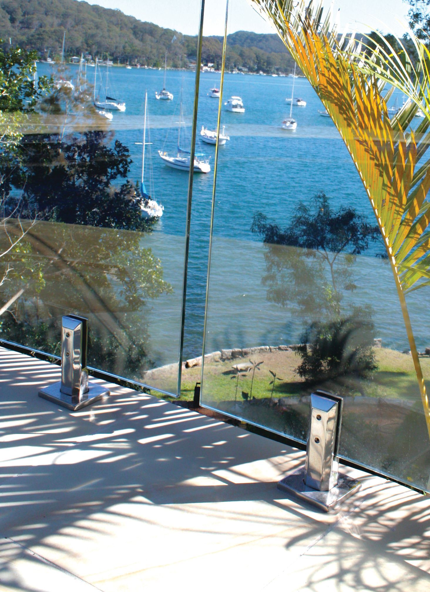 A Glass Railing with Metal Spigots — Coastline Glass Pool Fencing in Old Bar, NSW
