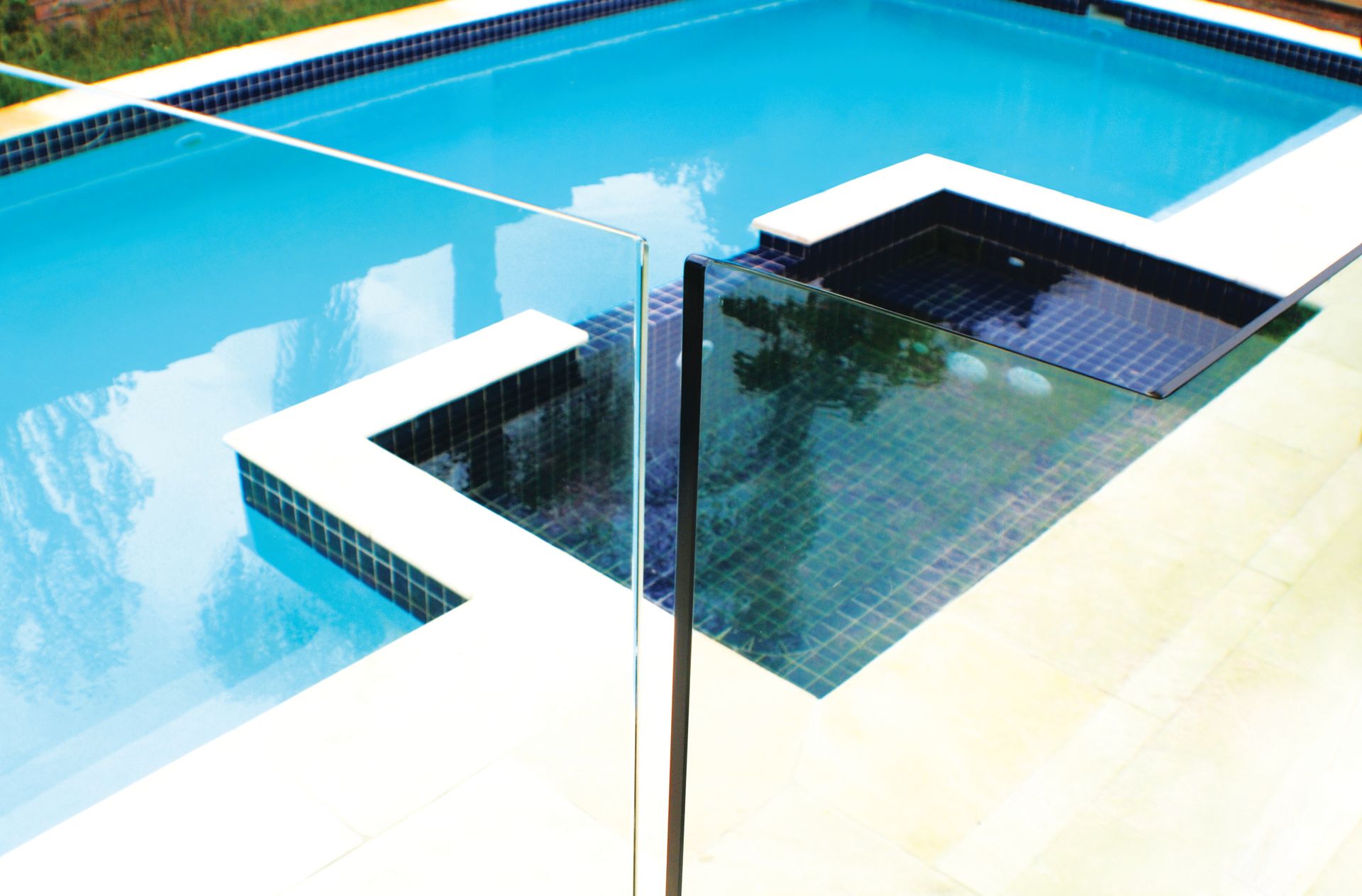 A Glass Safety Fence Overlooks a Swimming Pool — Coastline Glass Pool Fencing in Old Bar, NSW