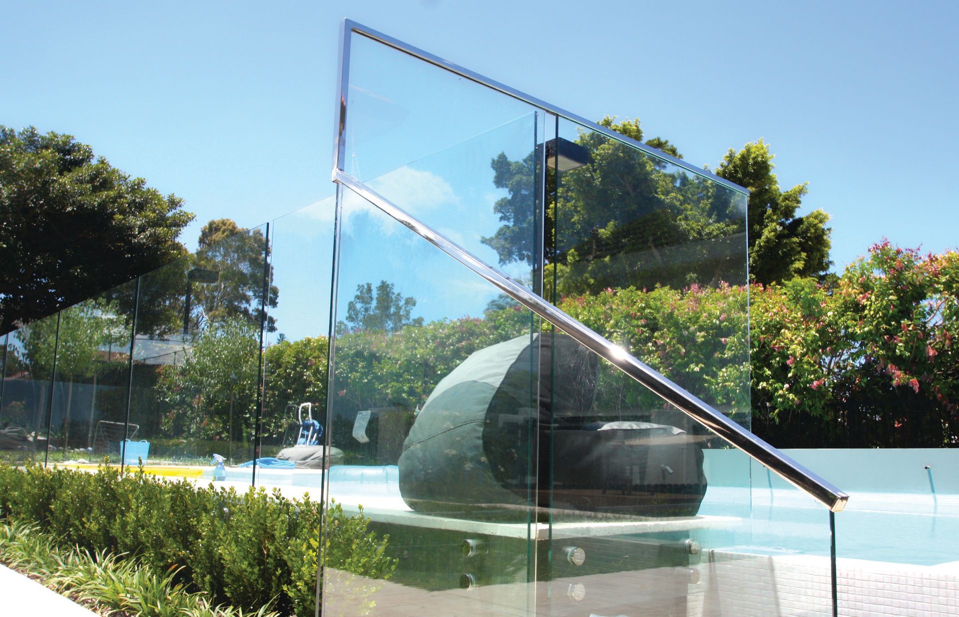A Glass Balustrade with A Metal Handrail — Coastline Glass Pool Fencing in Old Bar, NSW