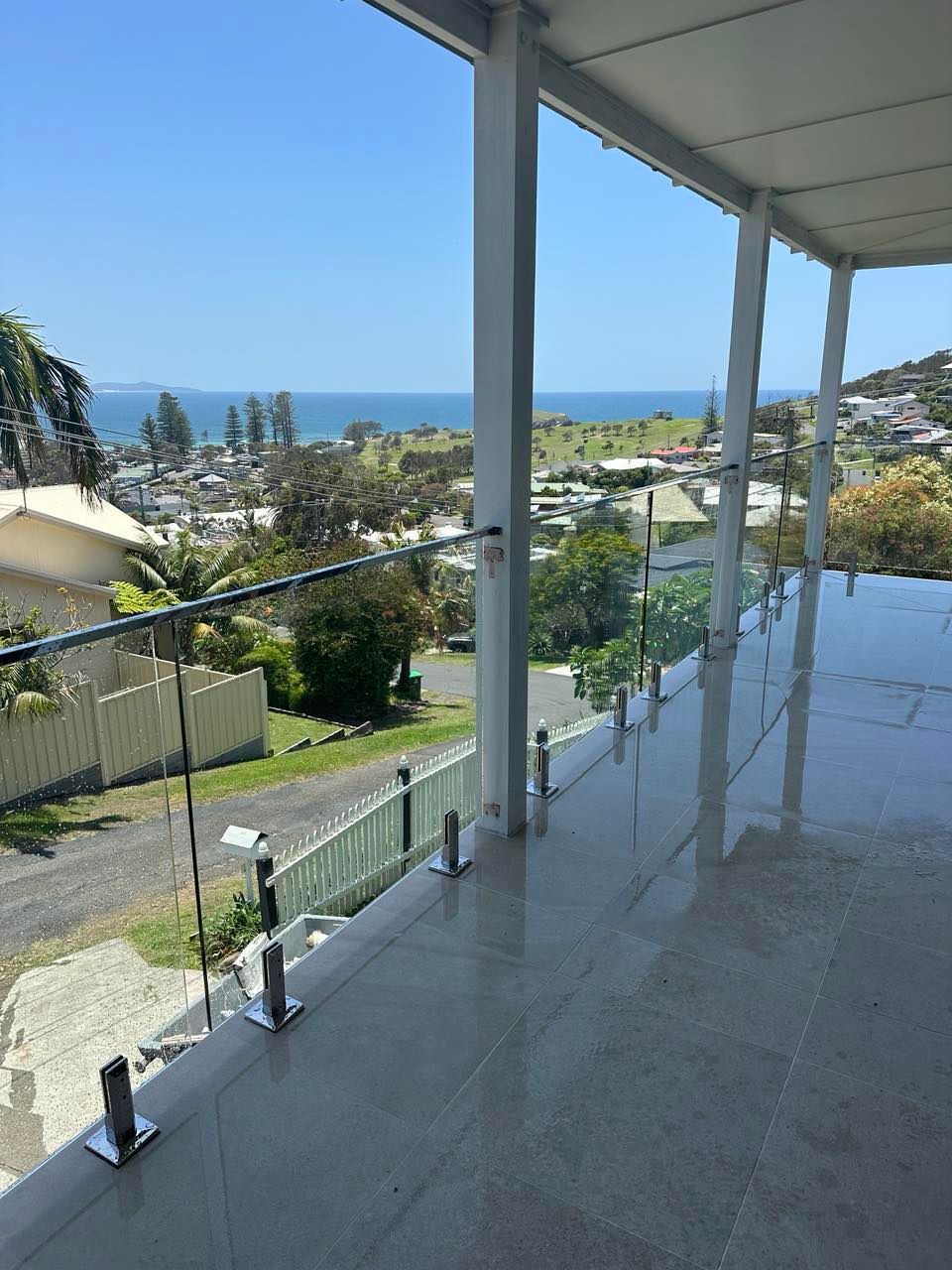 A Glass Railing with Stainless Steel Posts on A Balcony — Glass Pool Fencing Australia in Old Bar, NSW