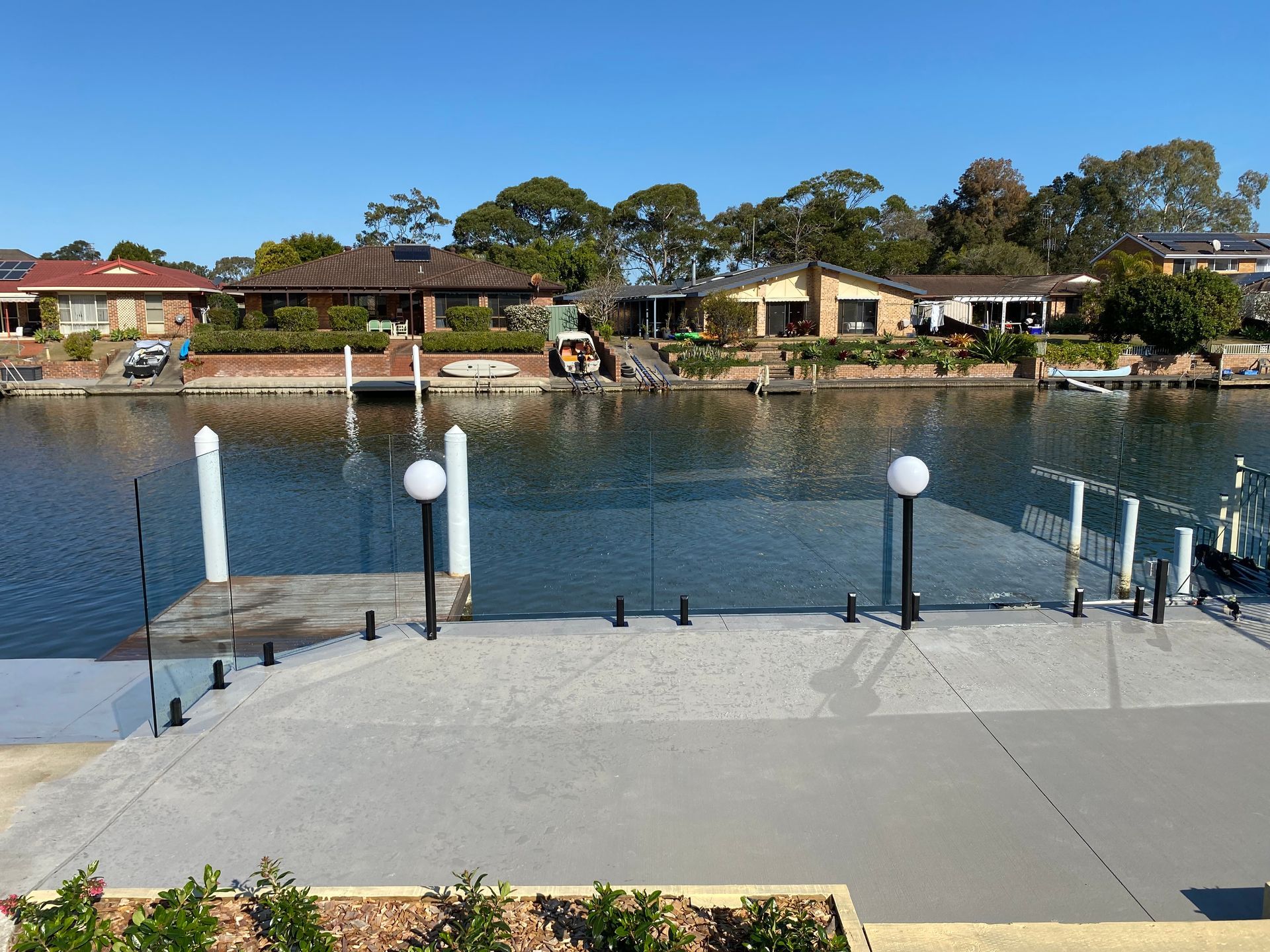A large body of water with houses in the background — Glass Pool Fencing Australia in Old Bar, NSW