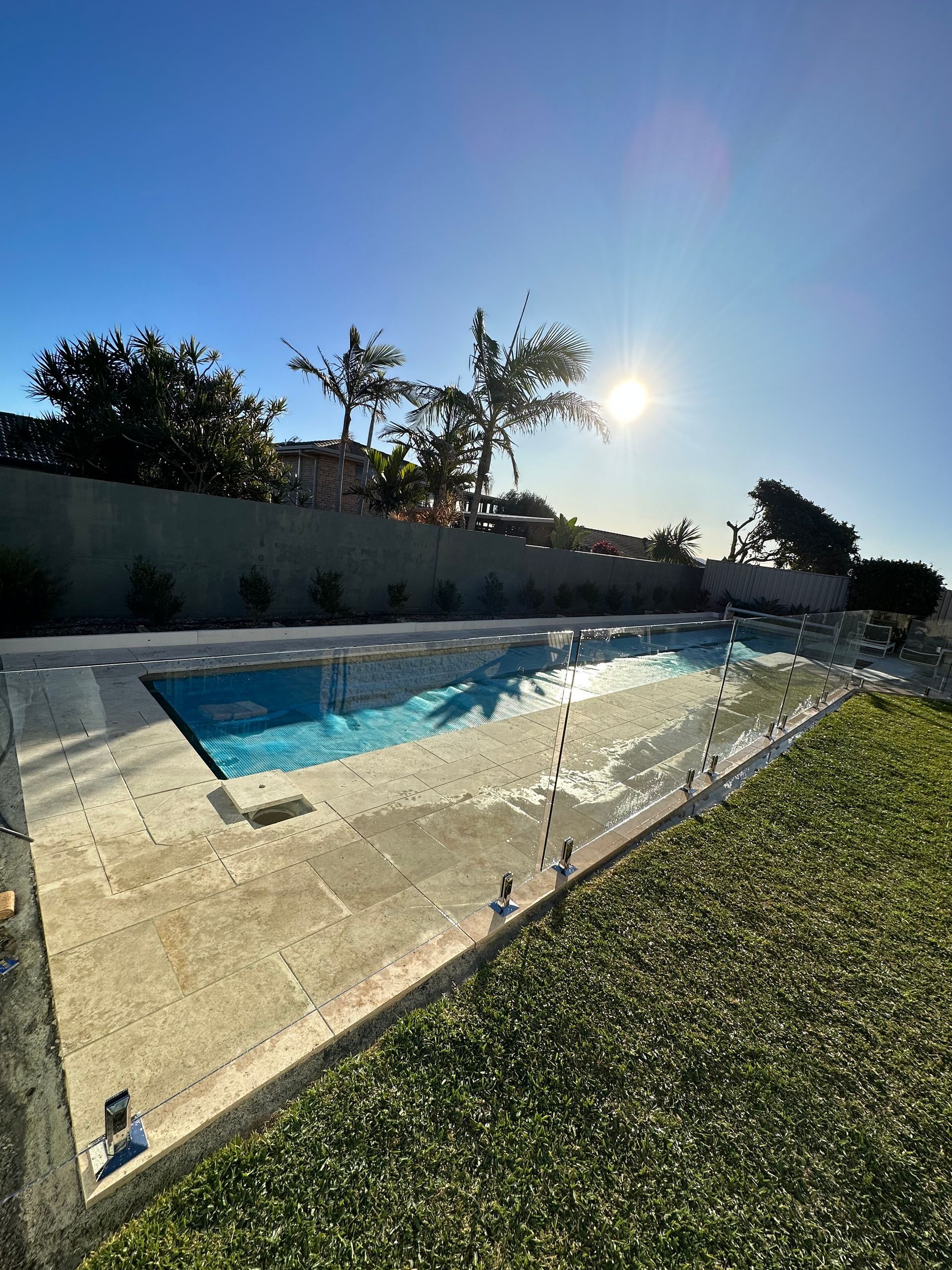 A Balcony with A Glass Railing Overlooking the Ocean — Glass Pool Fencing Australia in Old Bar, NSW