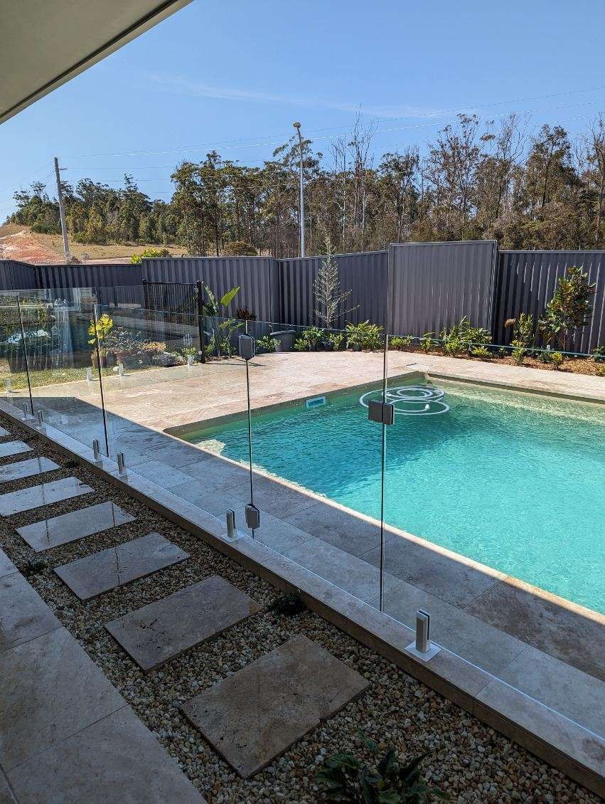 A House with A Swimming Pool in Front of It — Glass Pool Fencing Australia in Old Bar, NSW