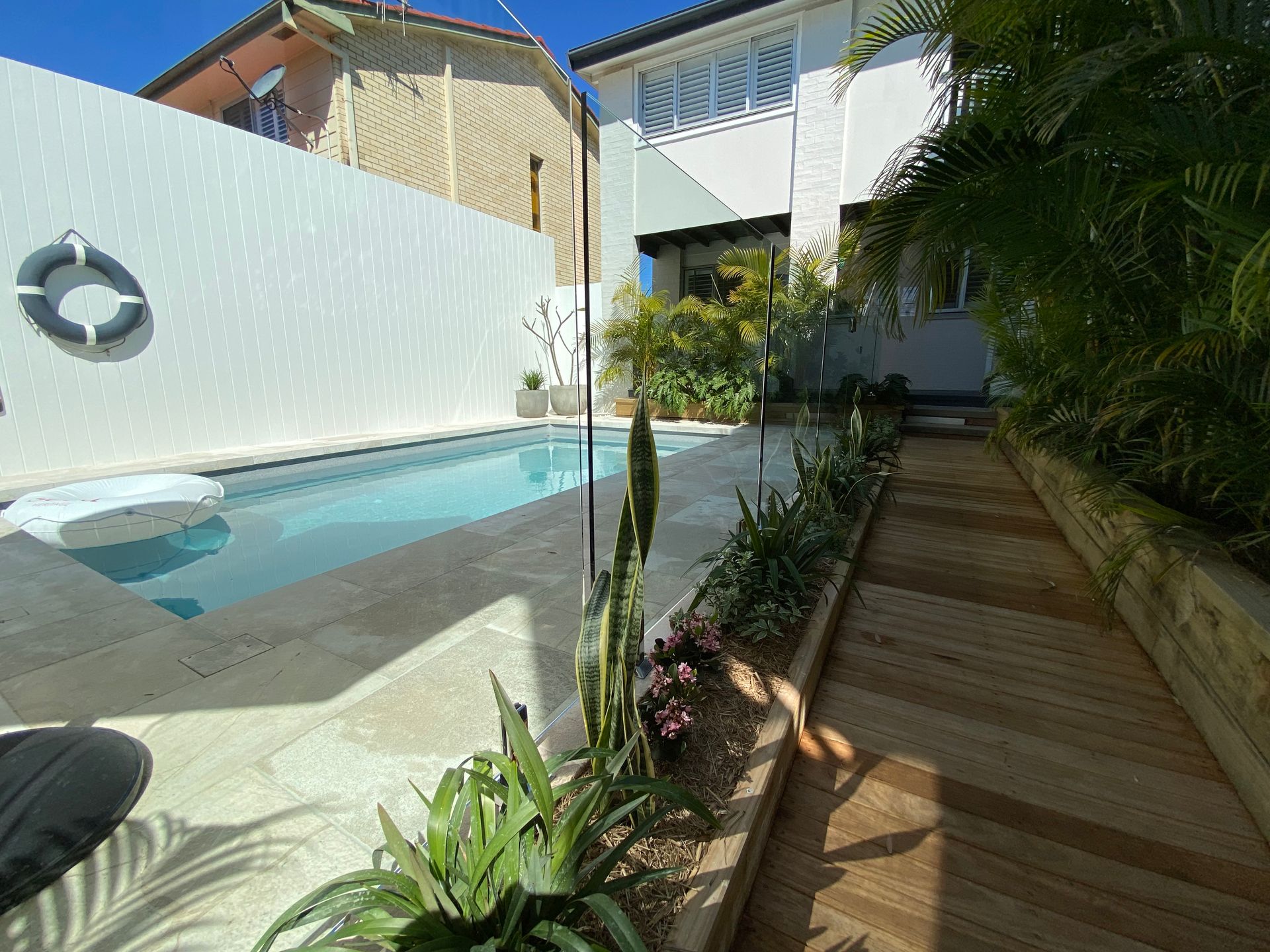 A Glass Railing with A Stainless Steel Handrail on A Bridge — Glass Pool Fencing Australia in Old Bar, NSW
