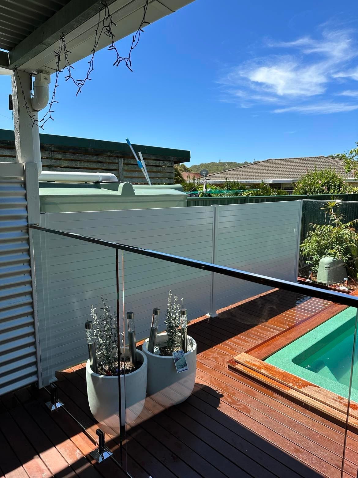 A Large Swimming Pool with A Glass Fence Around It — Glass Pool Fencing Australia in Old Bar, NSW
