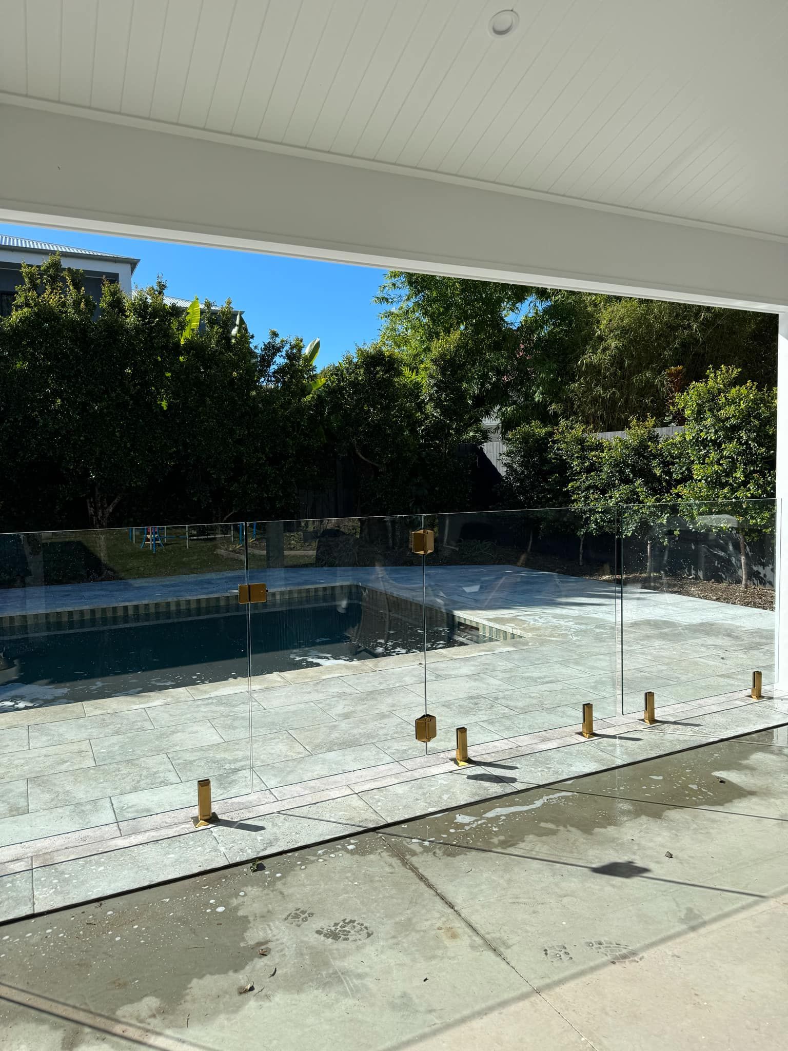 A Glass Pool Fence with Metal Spigots Installed — Coastline Glass Pool Fencing in Old Bar, NSW