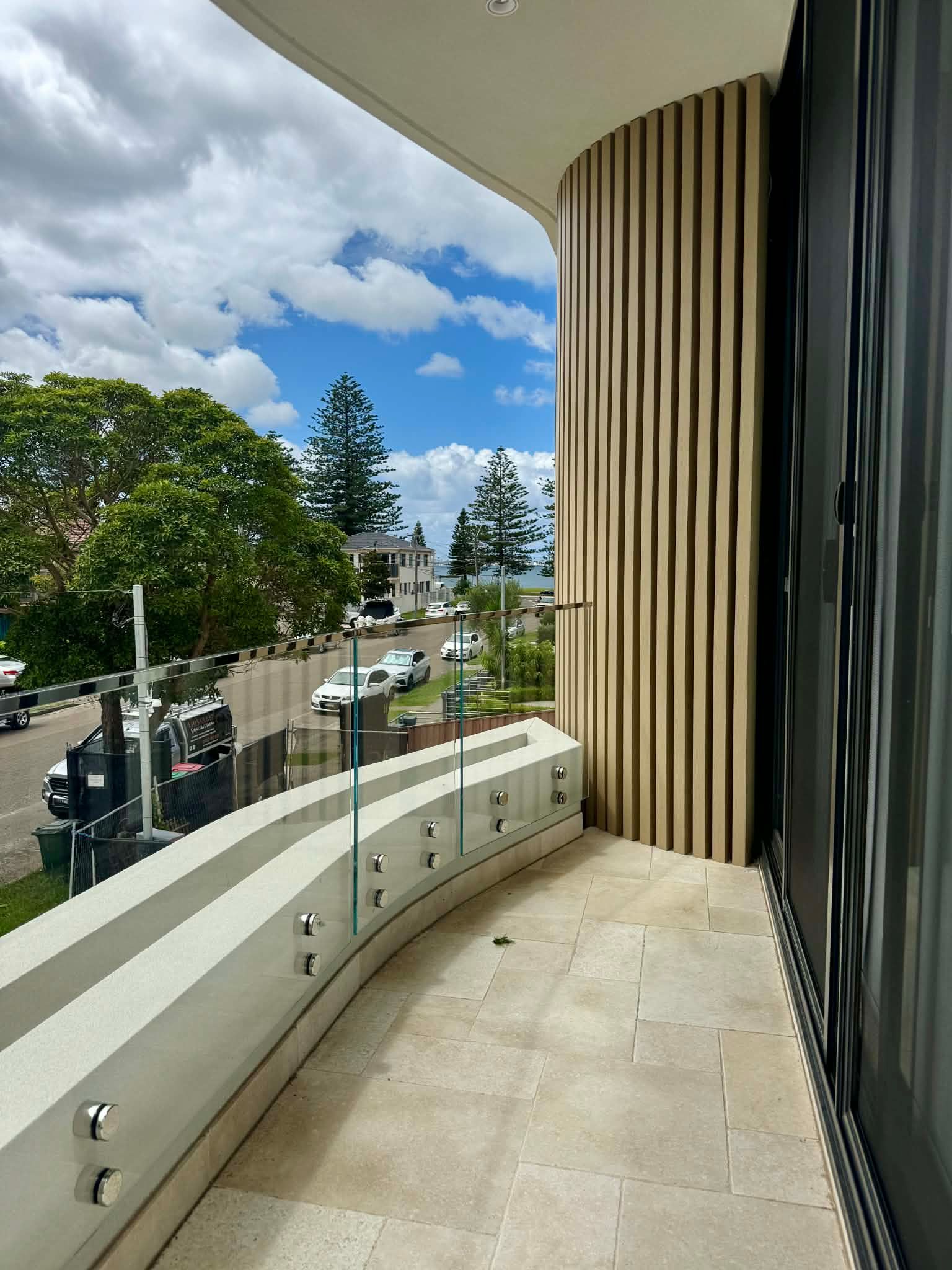 A Modern Balcony with Stone Flooring — Coastline Glass Pool Fencing in Old Bar, NSW