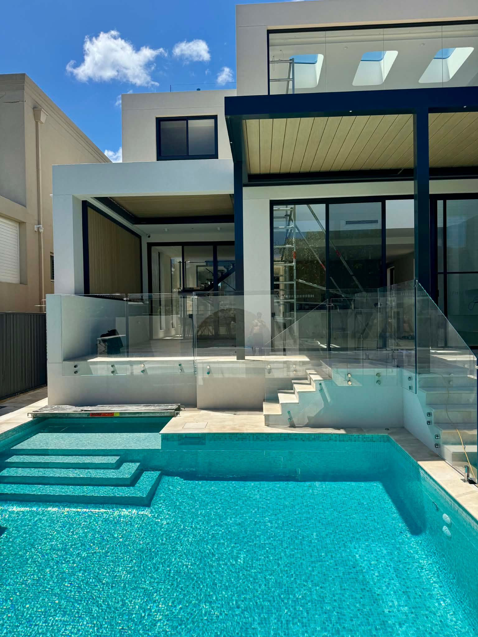 A Modern Two-Story Home with A Swimming Pool — Coastline Glass Pool Fencing in Old Bar, NSW