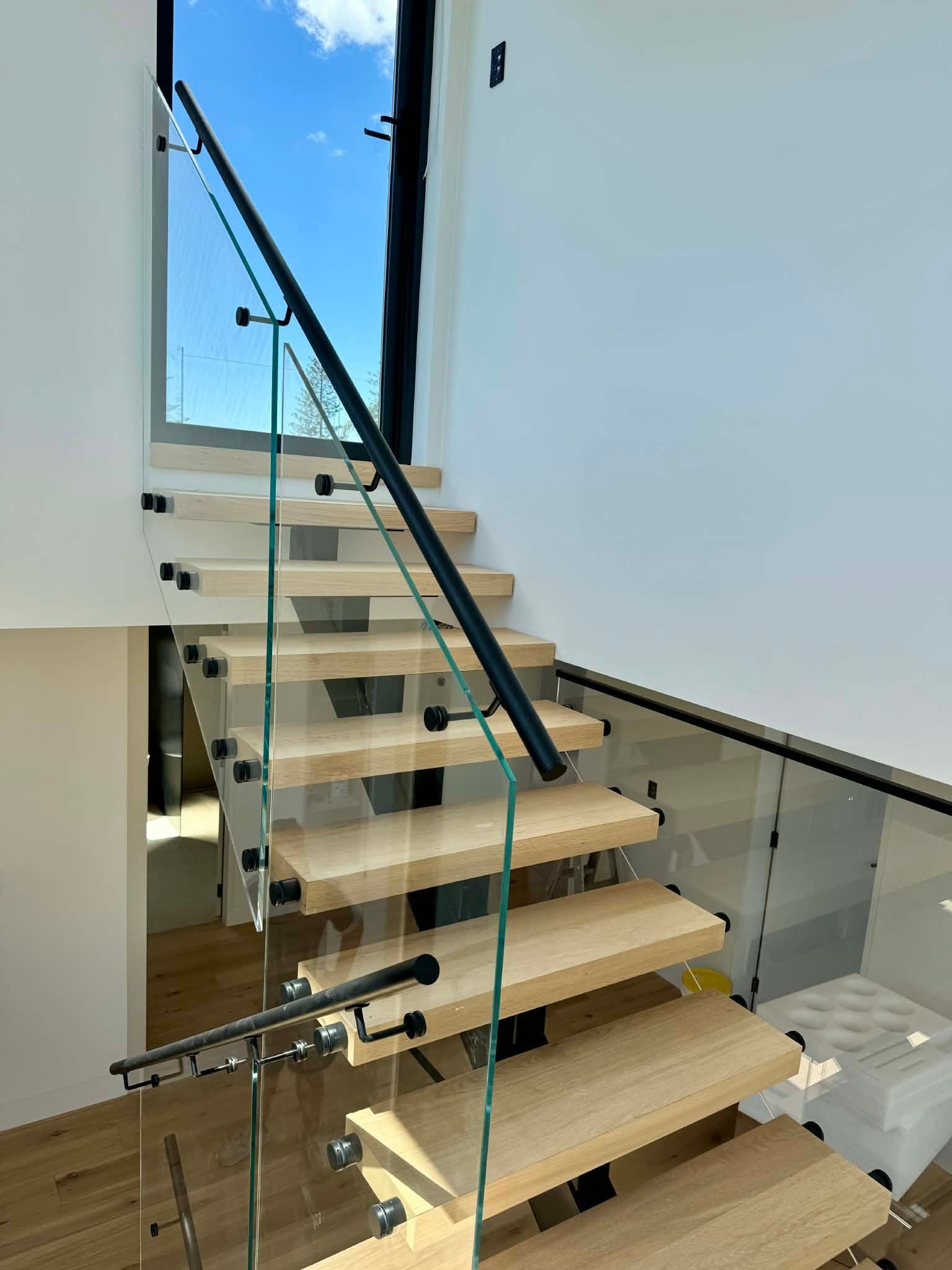 Modern Floating Staircase with Light Wood Treads — Coastline Glass Pool Fencing in Old Bar, NSW