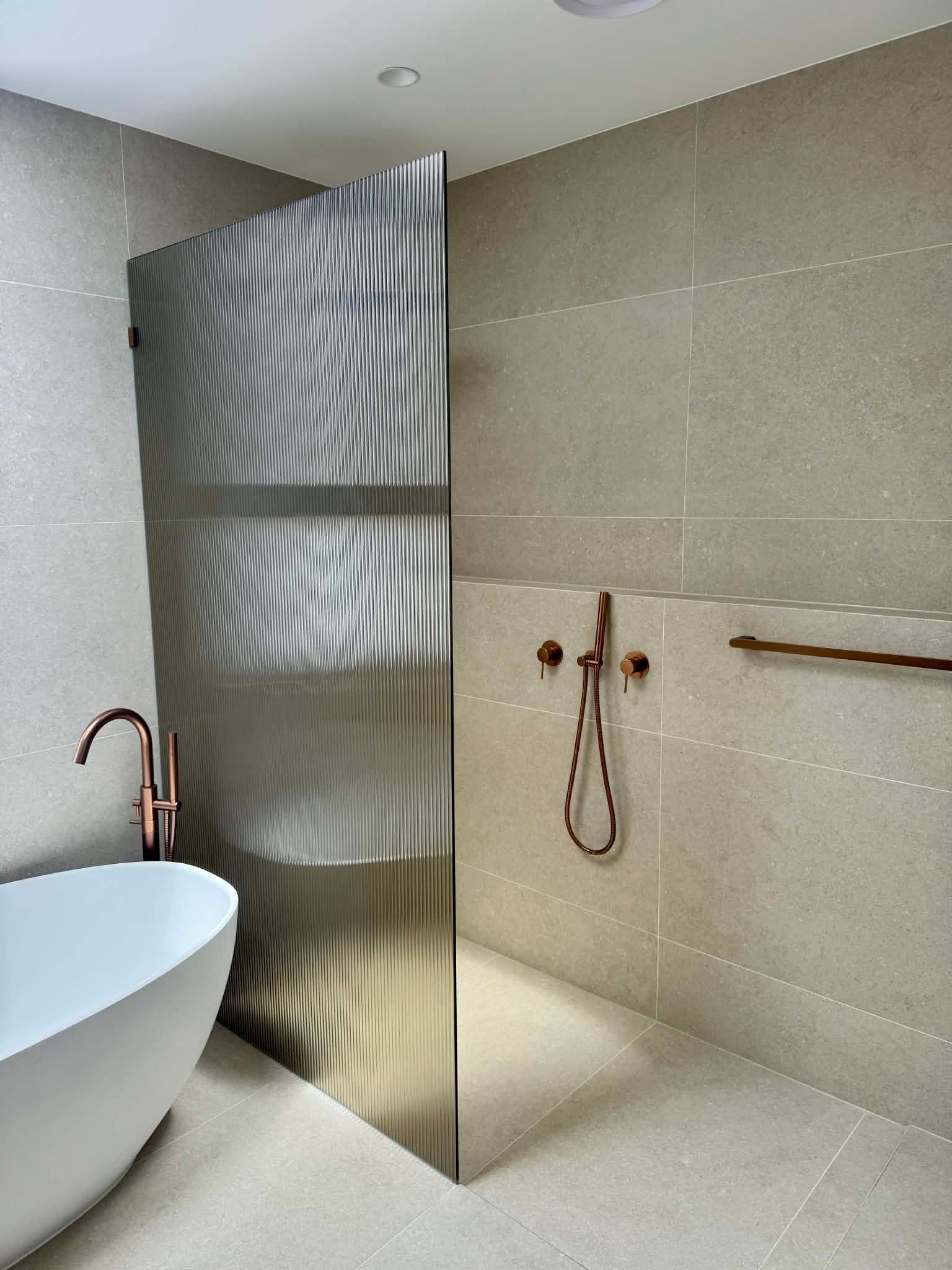 A Modern Bathroom Featuring a Walk-In Shower — Coastline Glass Pool Fencing in Old Bar, NSW