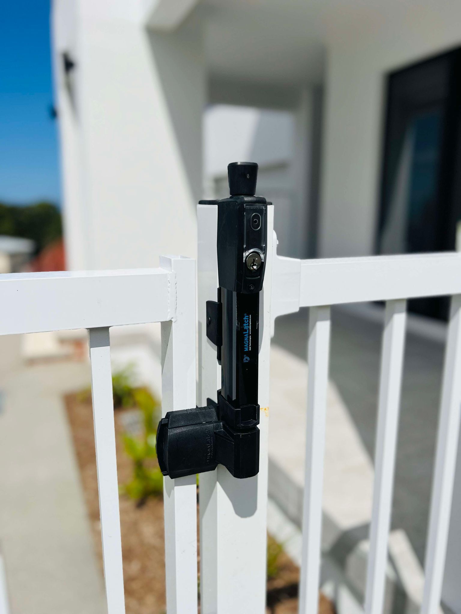 A Wrought Iron Fence Surrounds a Swimming Pool in A Backyard — Glass Pool Fencing Australia in Old Bar, NSW