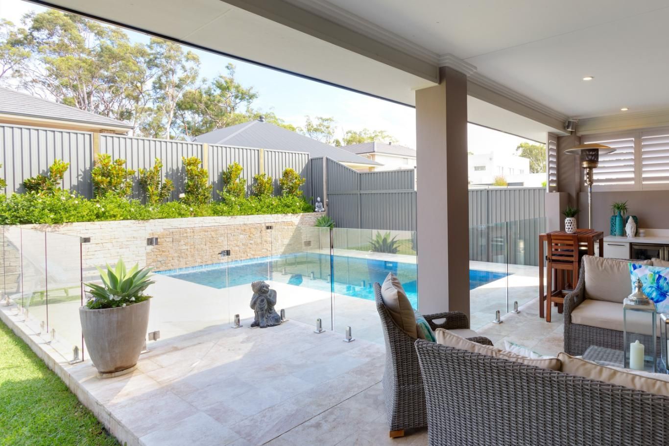 A Spacious Outdoor Patio with Wicker Furniture — Coastline Glass Pool Fencing in Old Bar, NSW
