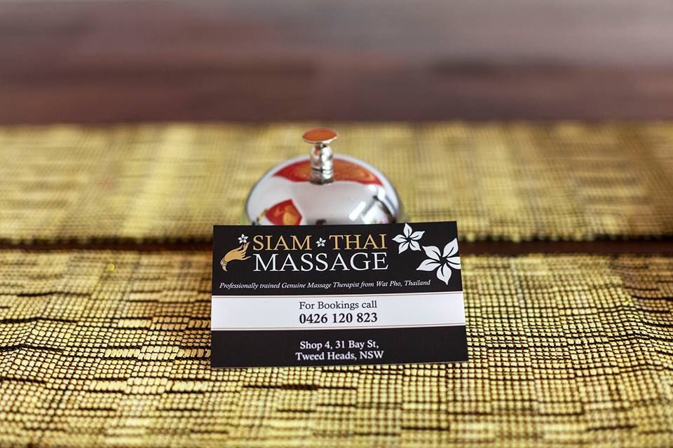 A Business Card for Siam Thai Massage is Sitting on a Table — Siam Thai Massage In Tweed Heads, NSW