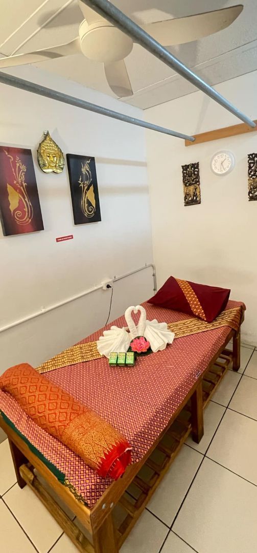 There is a Bed in the Middle of a Room With a Ceiling Fan — Siam Thai Massage In Tweed Heads, NSW