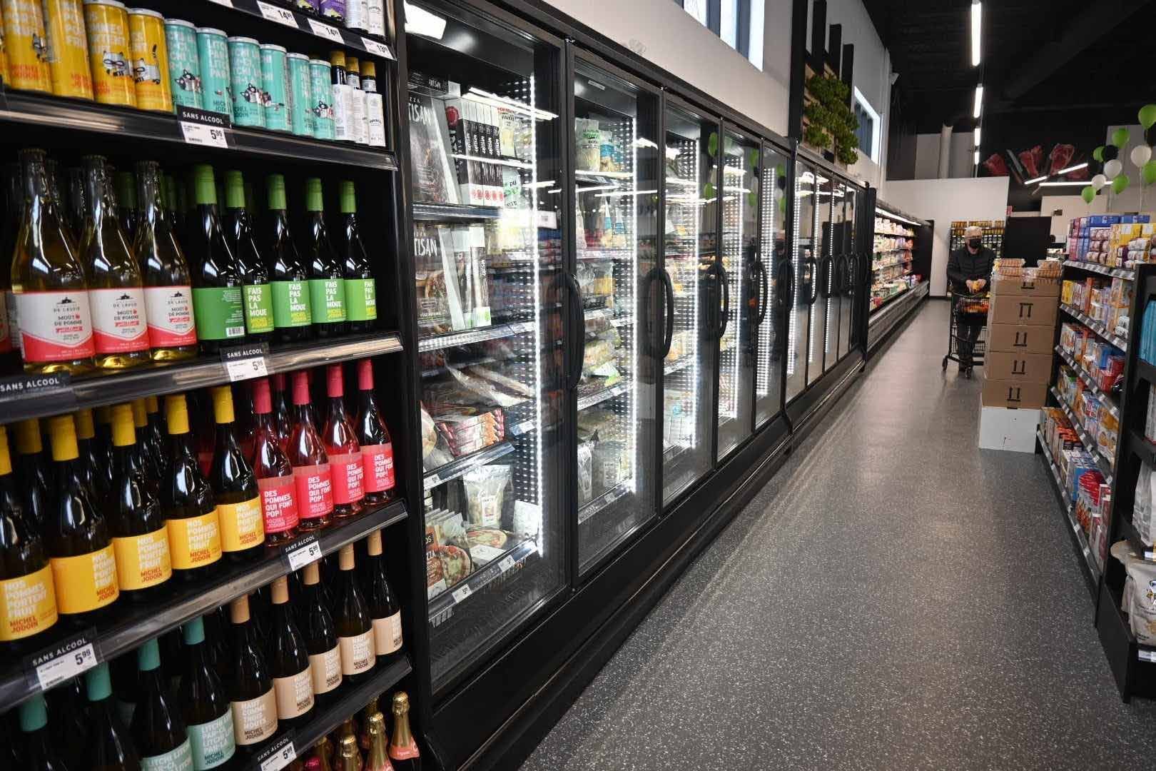 Une allée d'épicerie remplie de nombreuses bouteilles et canettes.